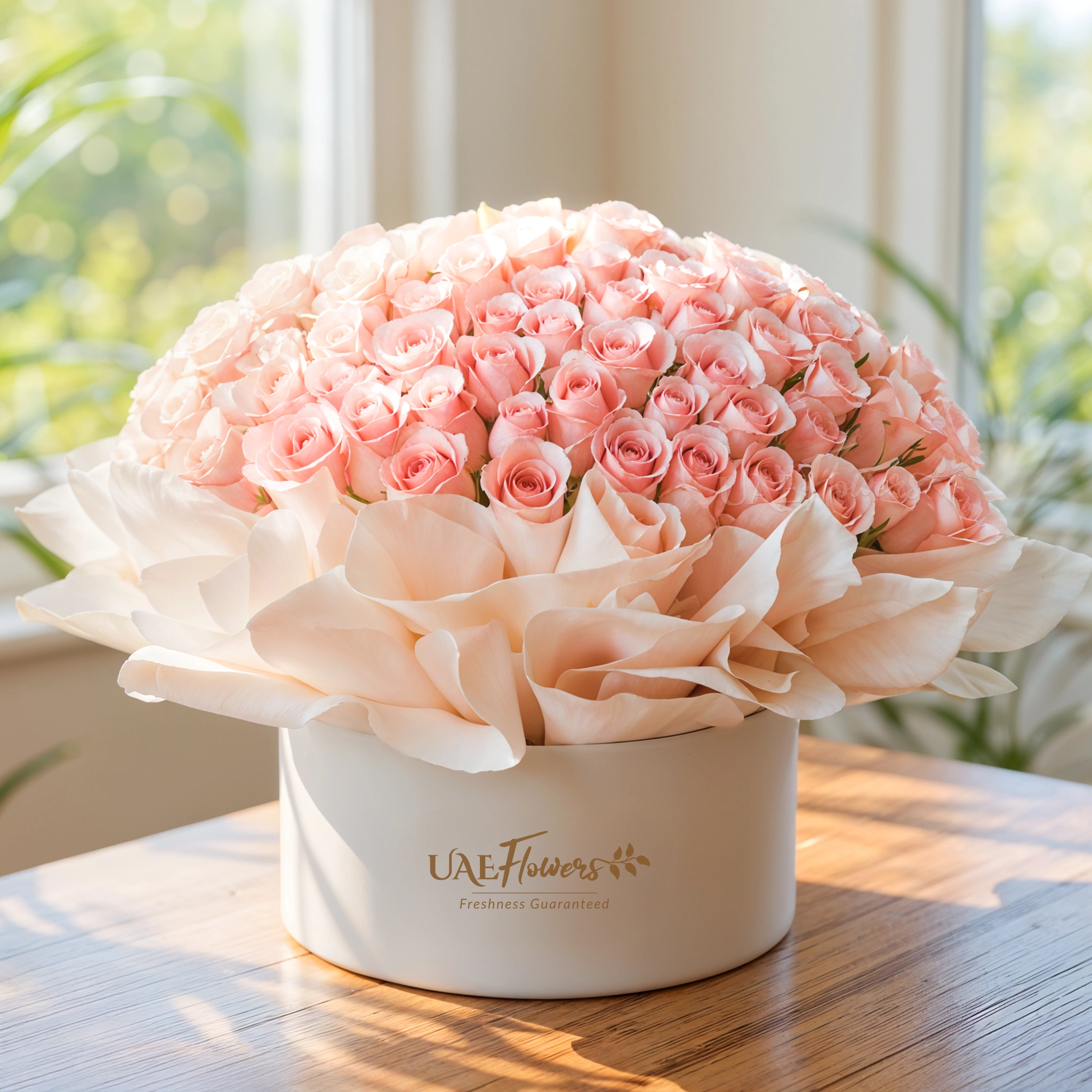 100 pink roses arranged in a box with stylish paper wrapping