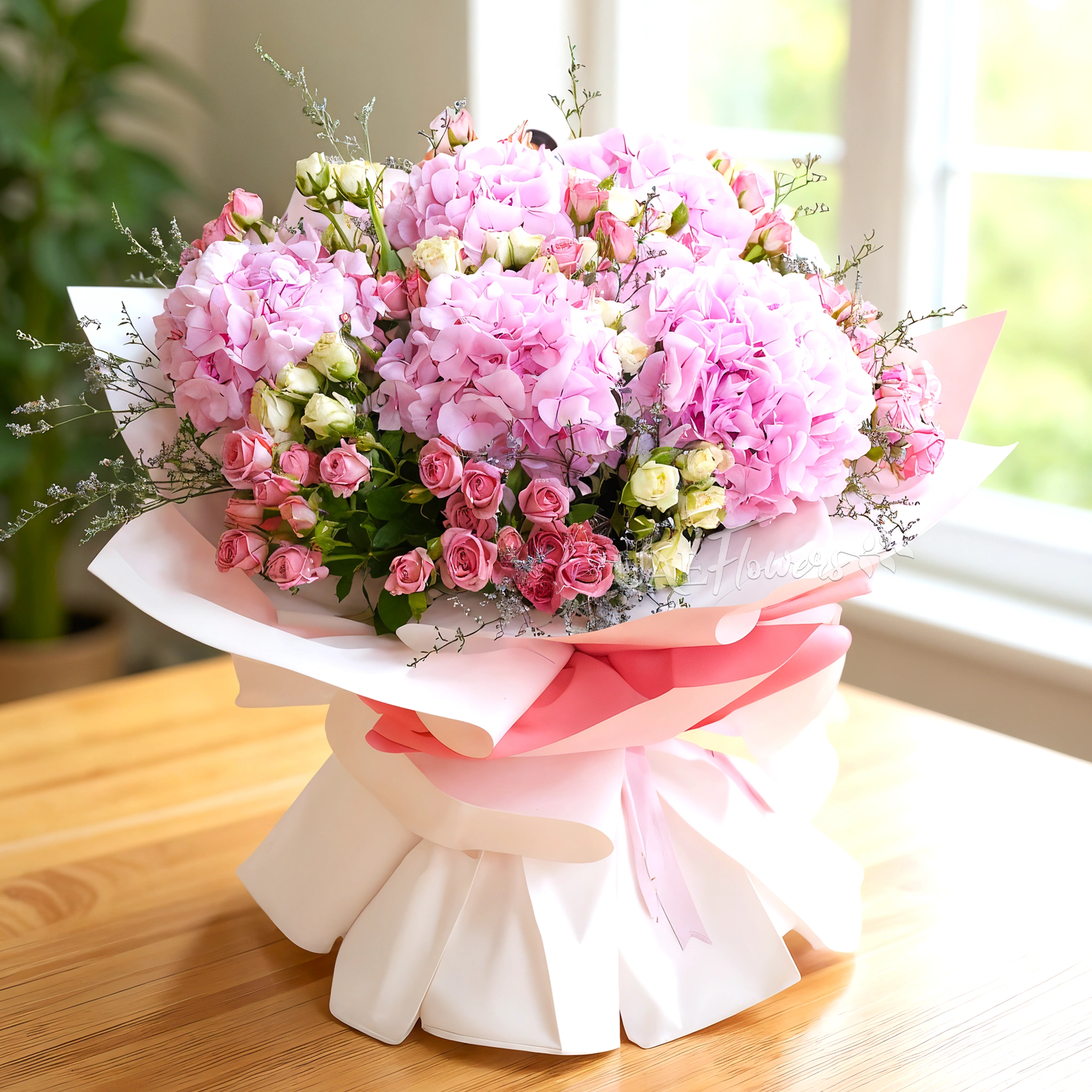 bouquet with 5 pink hydrangeas, 10 pink and white spray roses, and green fillers.