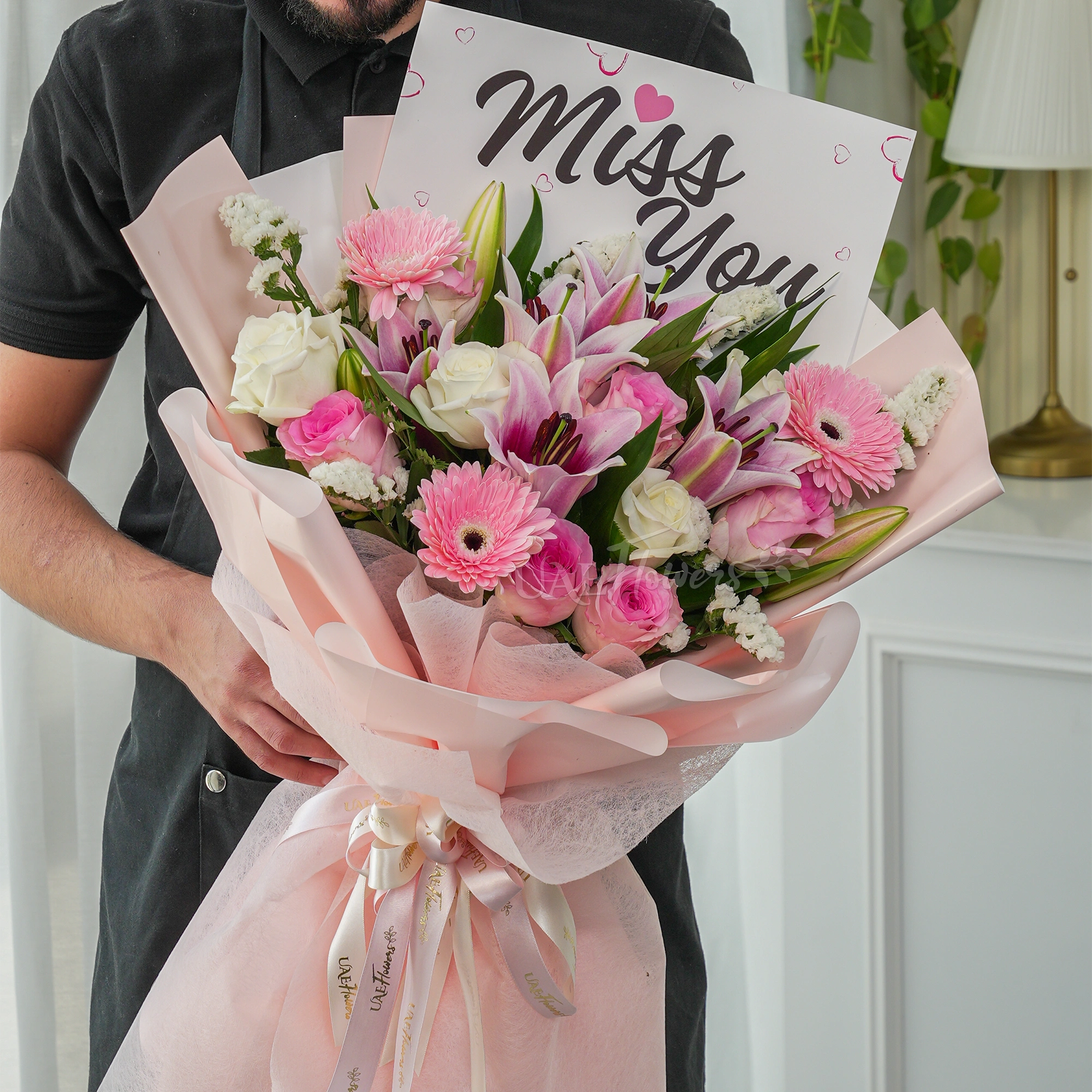 Bouquet of 5 pink roses, 5 white roses, 3 pink gerberas and 2 pink lilies with green fillers.