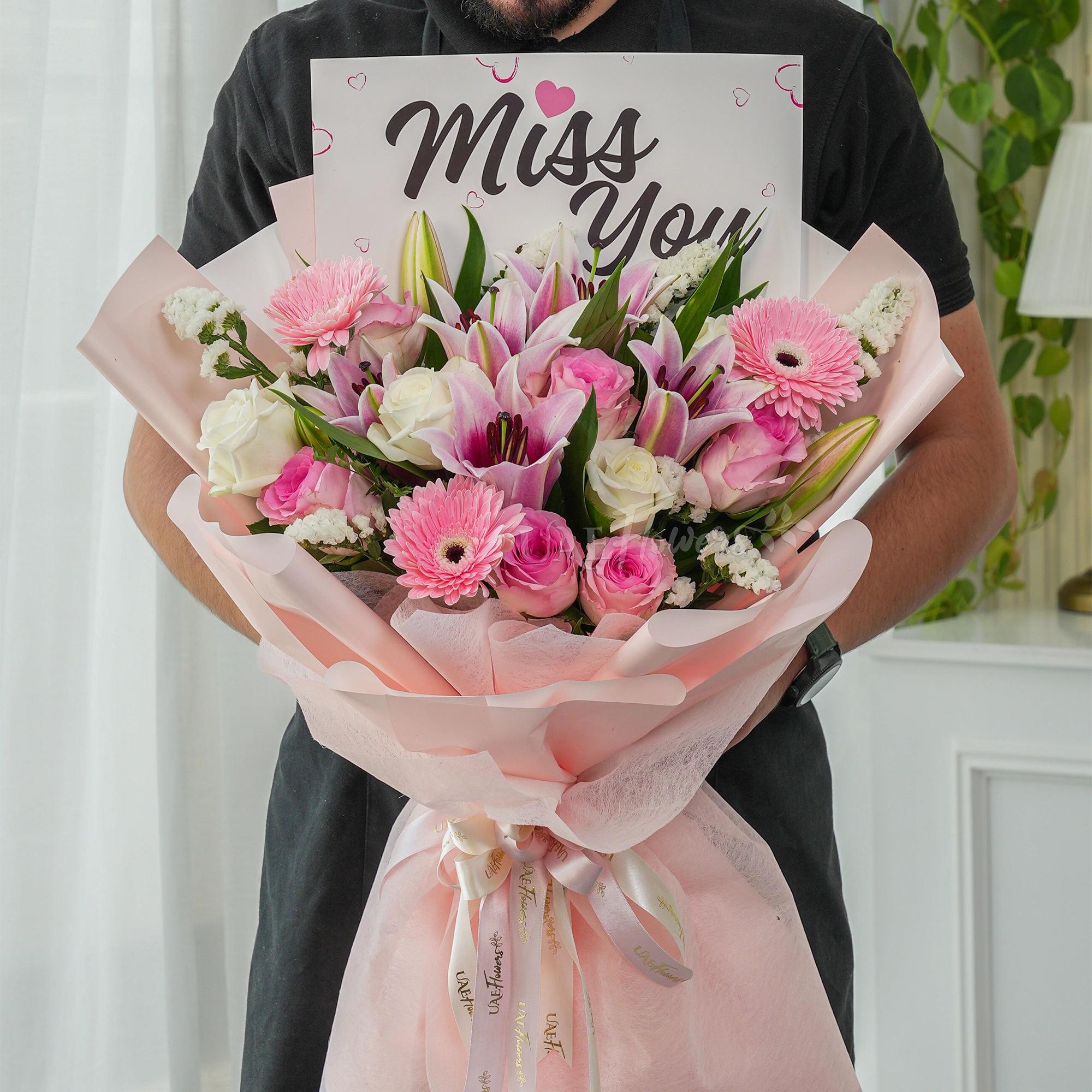Bouquet of 5 pink roses, 5 white roses, 3 pink gerberas and 2 pink lilies with green fillers.