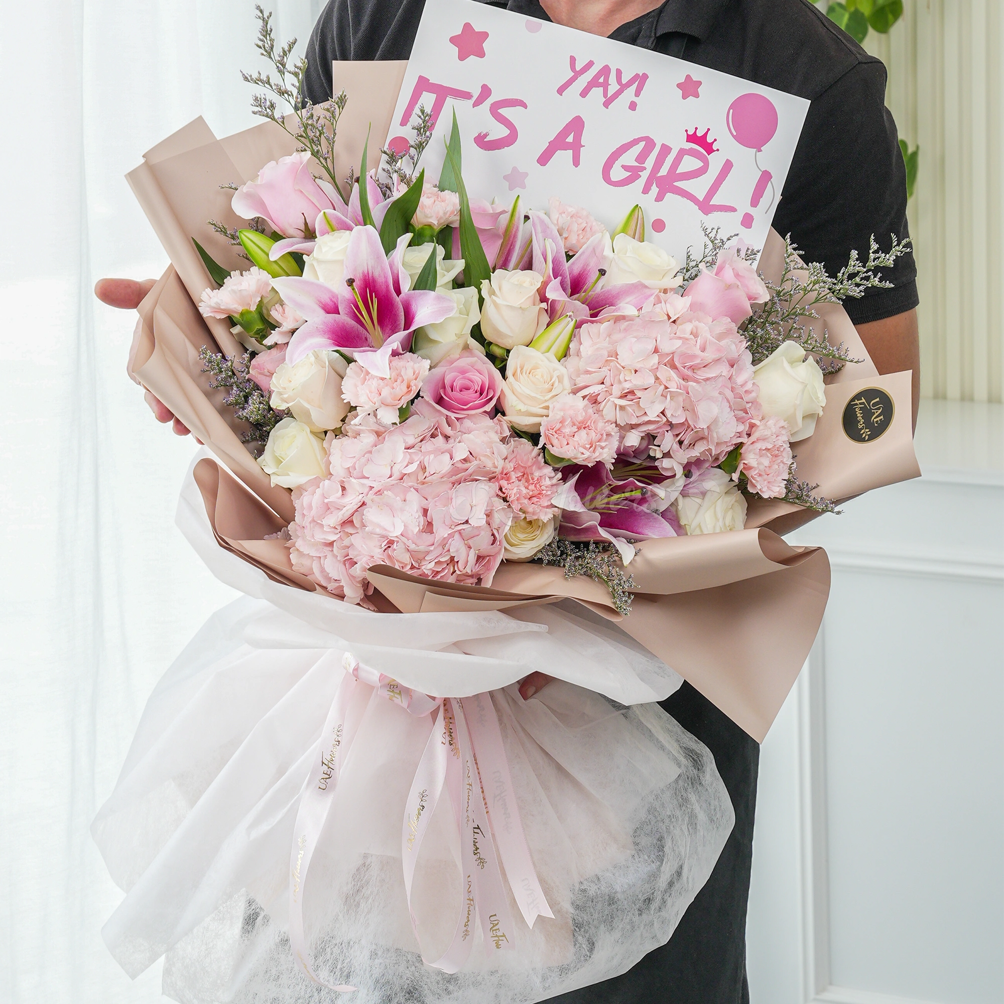 Bouquet of 2 pink hydrangeas, 2 pink lilies, 10 white roses and 5 pink carnations with limonium fillers in nice wrapping