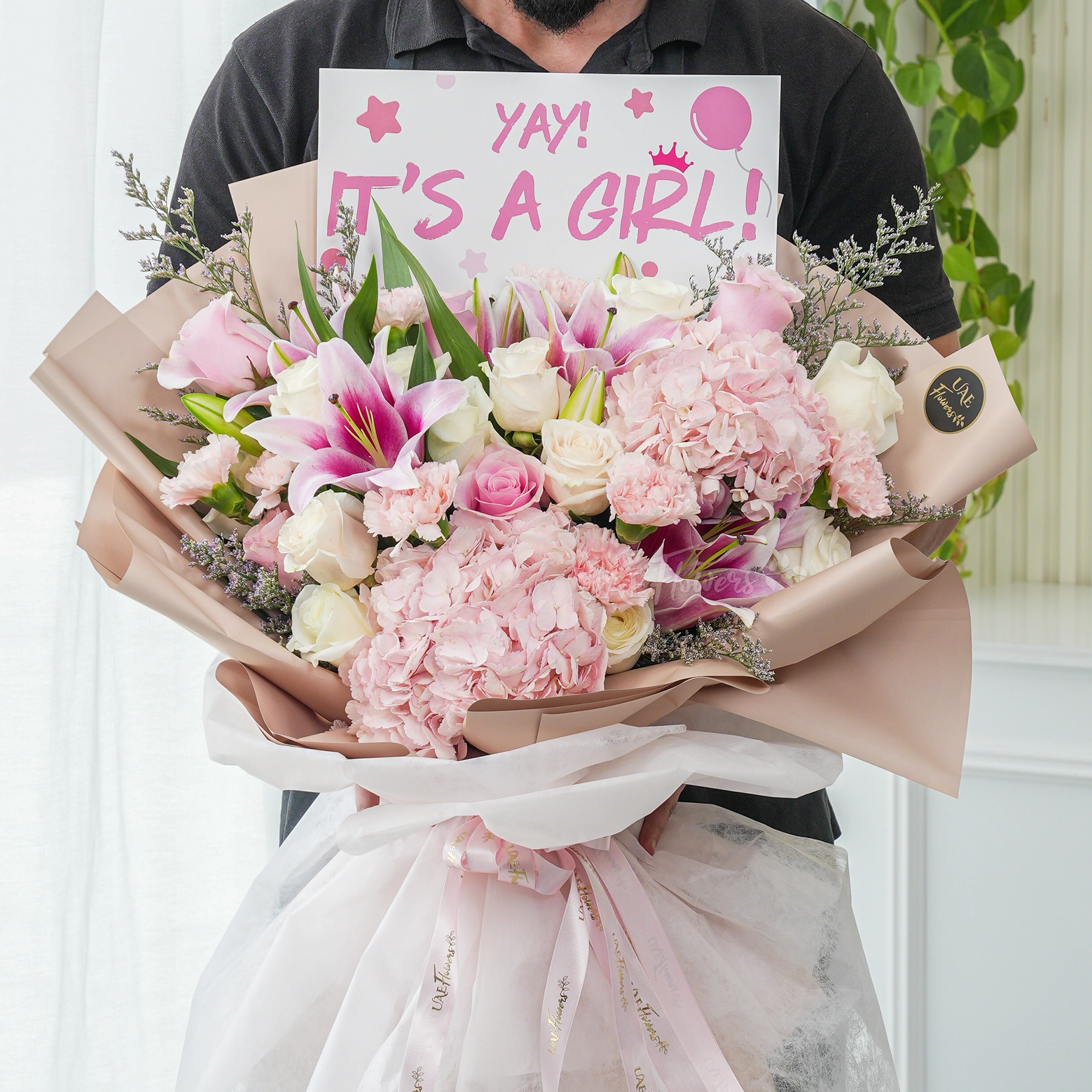 Bouquet of 2 pink hydrangeas, 2 pink lilies, 10 white roses and 5 pink carnations with limonium fillers in nice wrapping