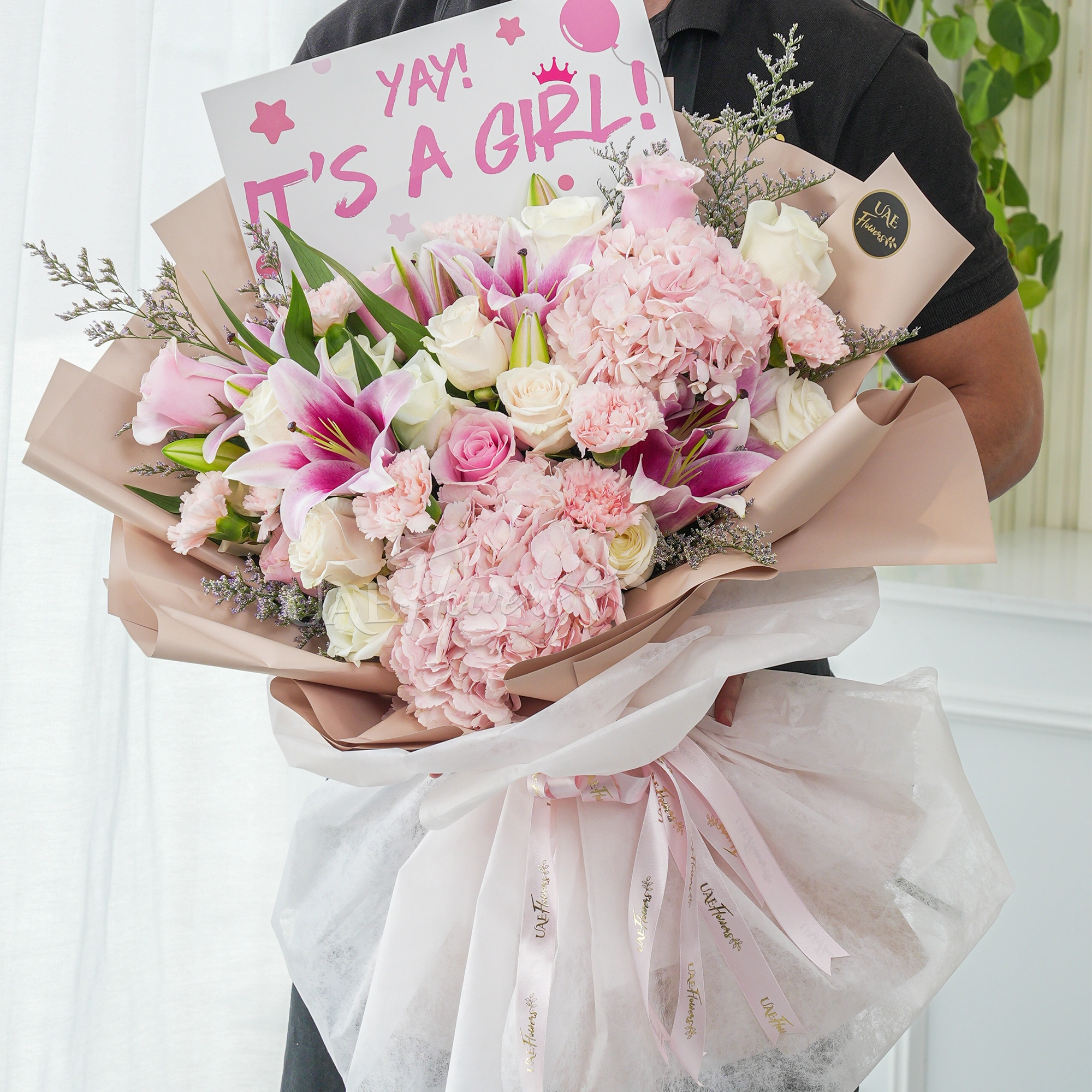 Bouquet of 2 pink hydrangeas, 2 pink lilies, 10 white roses and 5 pink carnations with limonium fillers in nice wrapping