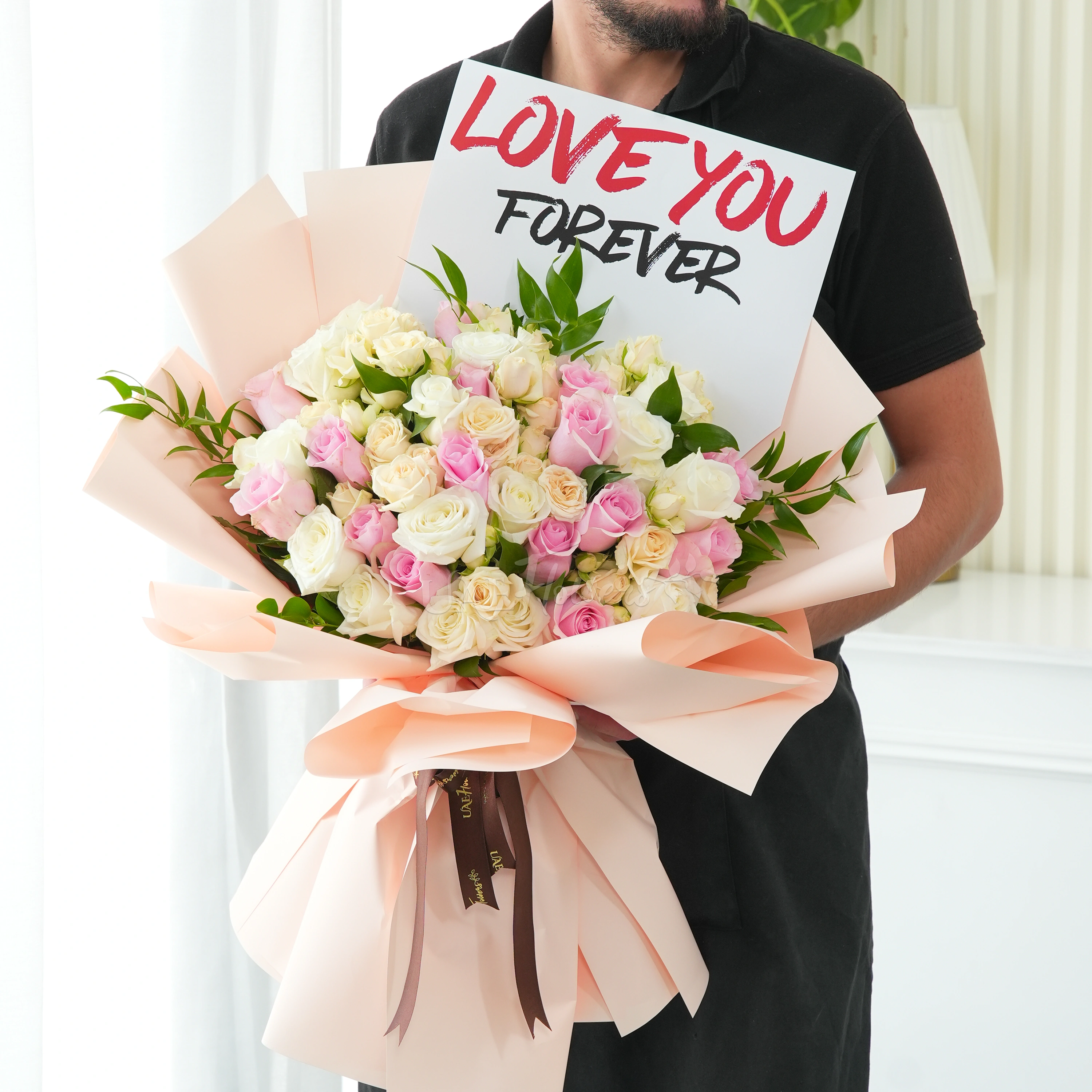 Bouquet of 40 pink, peach and white roses with greens in nice wrapping