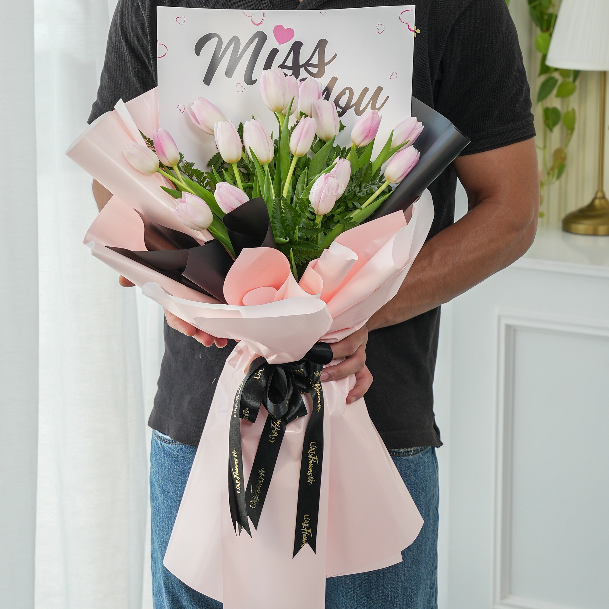 Bouquet of 20 pink tulips with green fillers and Miss You paper.