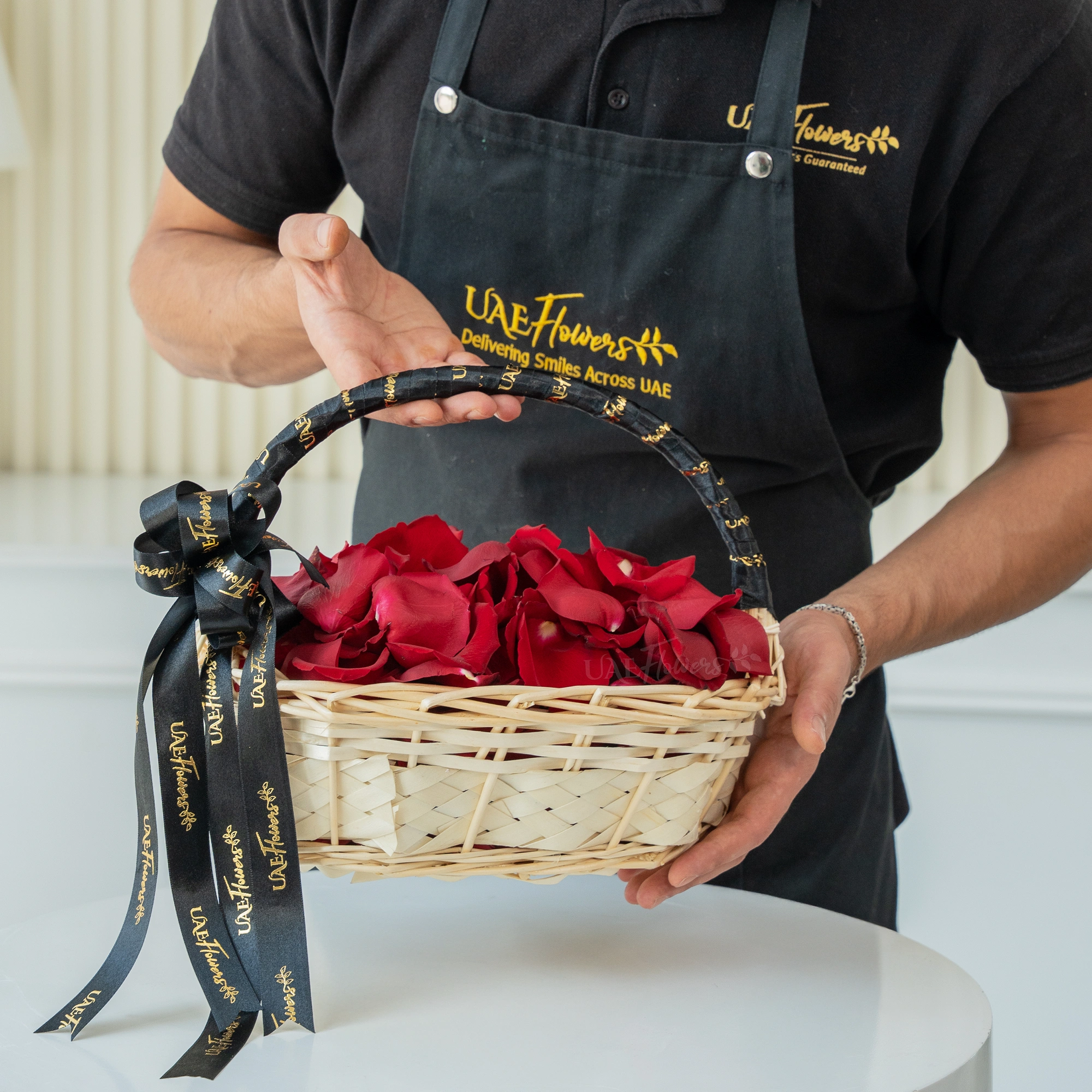 red rose petals arranged in a handled basket