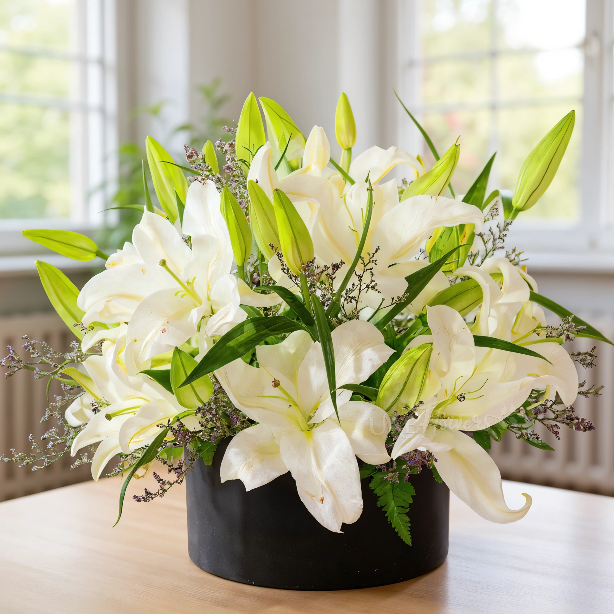 6 white lilies with limonium and green fillers in a black box