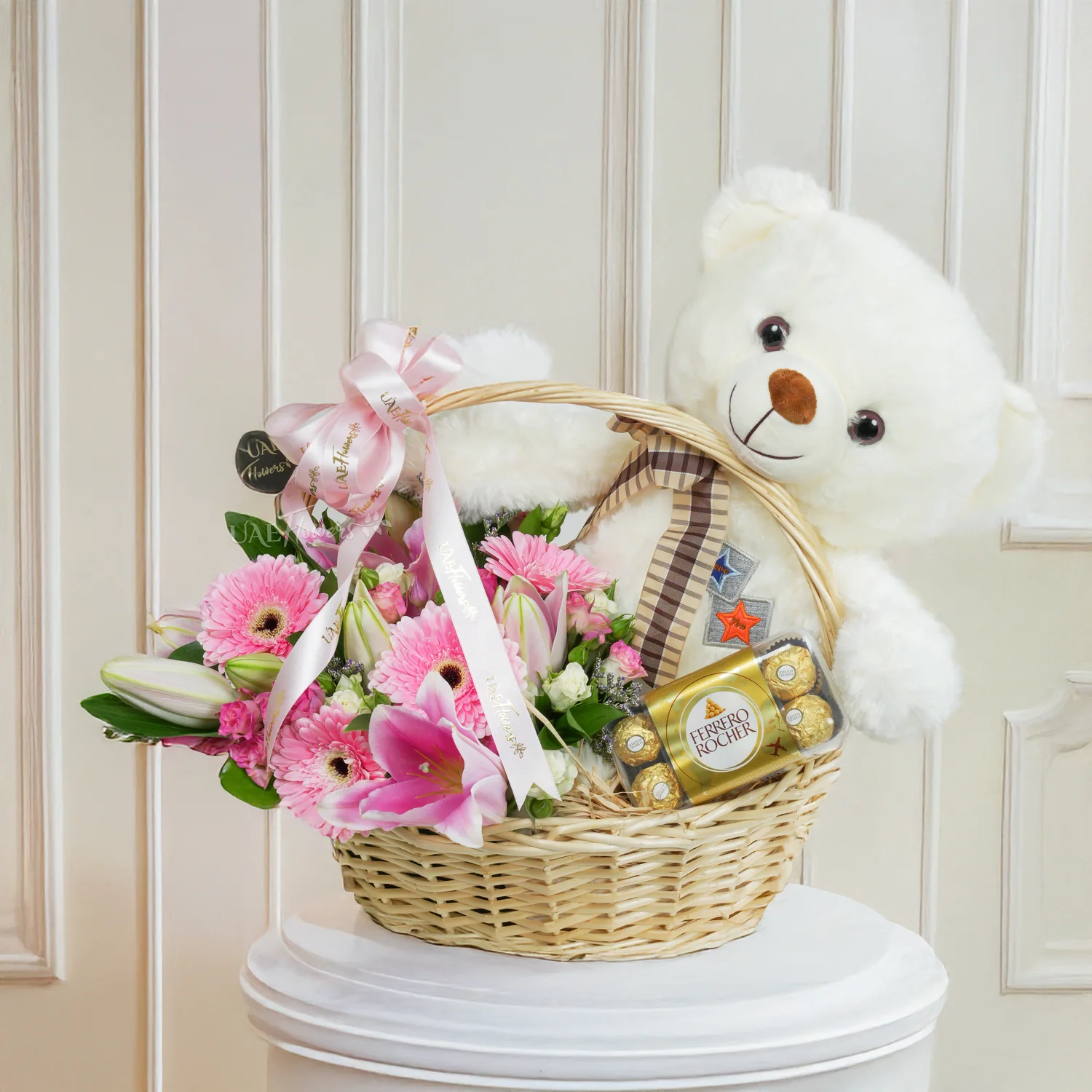 basket arrangement with 5 pink gerberas, 2 pink lilies, 4 pink and white spray roses,