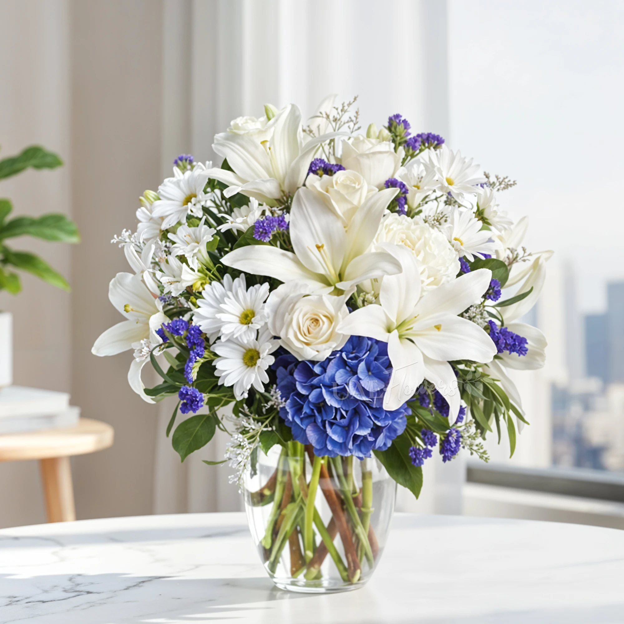 3 alstroemeria, 4 white chrysanthemums, 3 white roses, 2 white Lilies, 3 purple statice, and blue hydrangea in a clear glass vase
