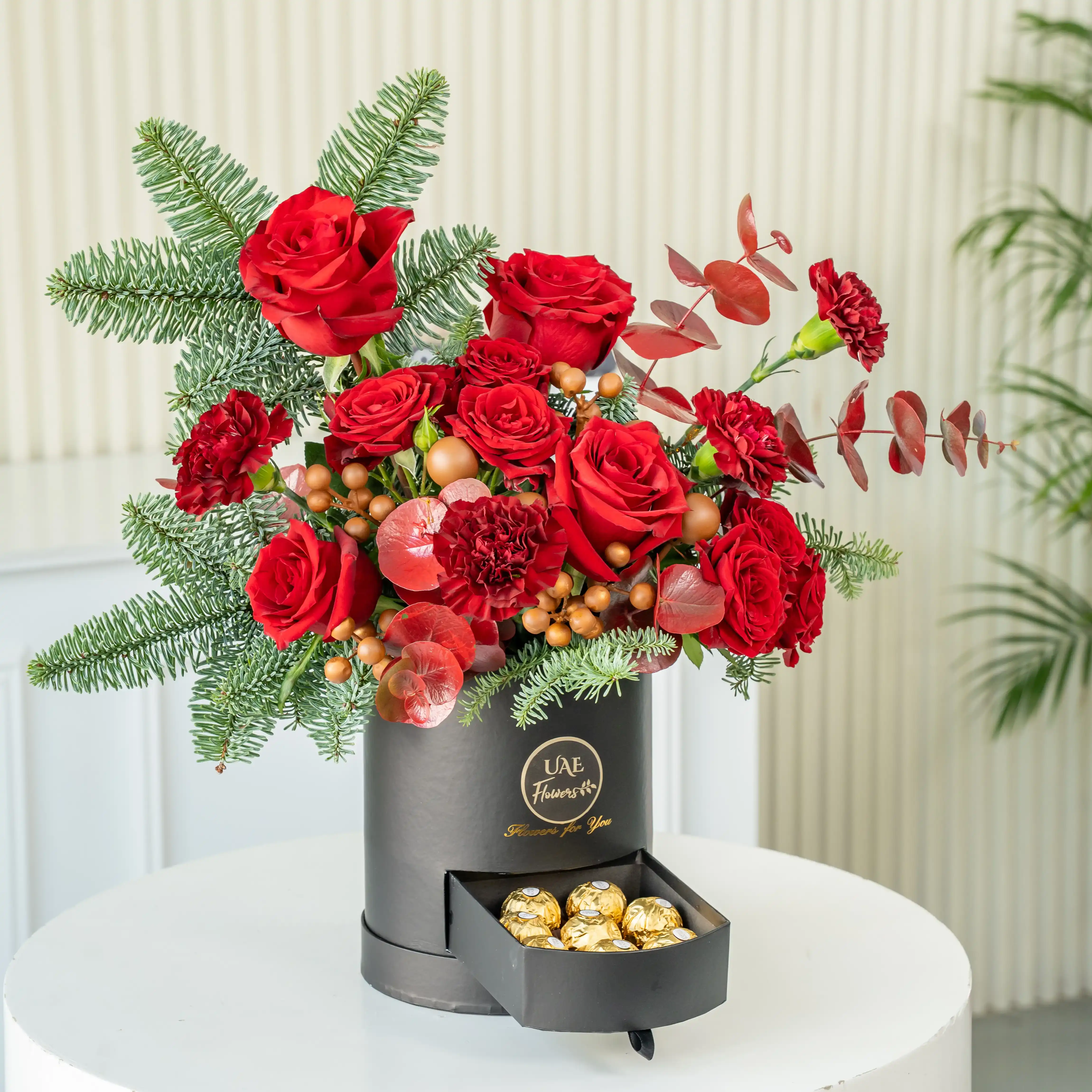 Red rose and pine Christmas flower box with chocolates