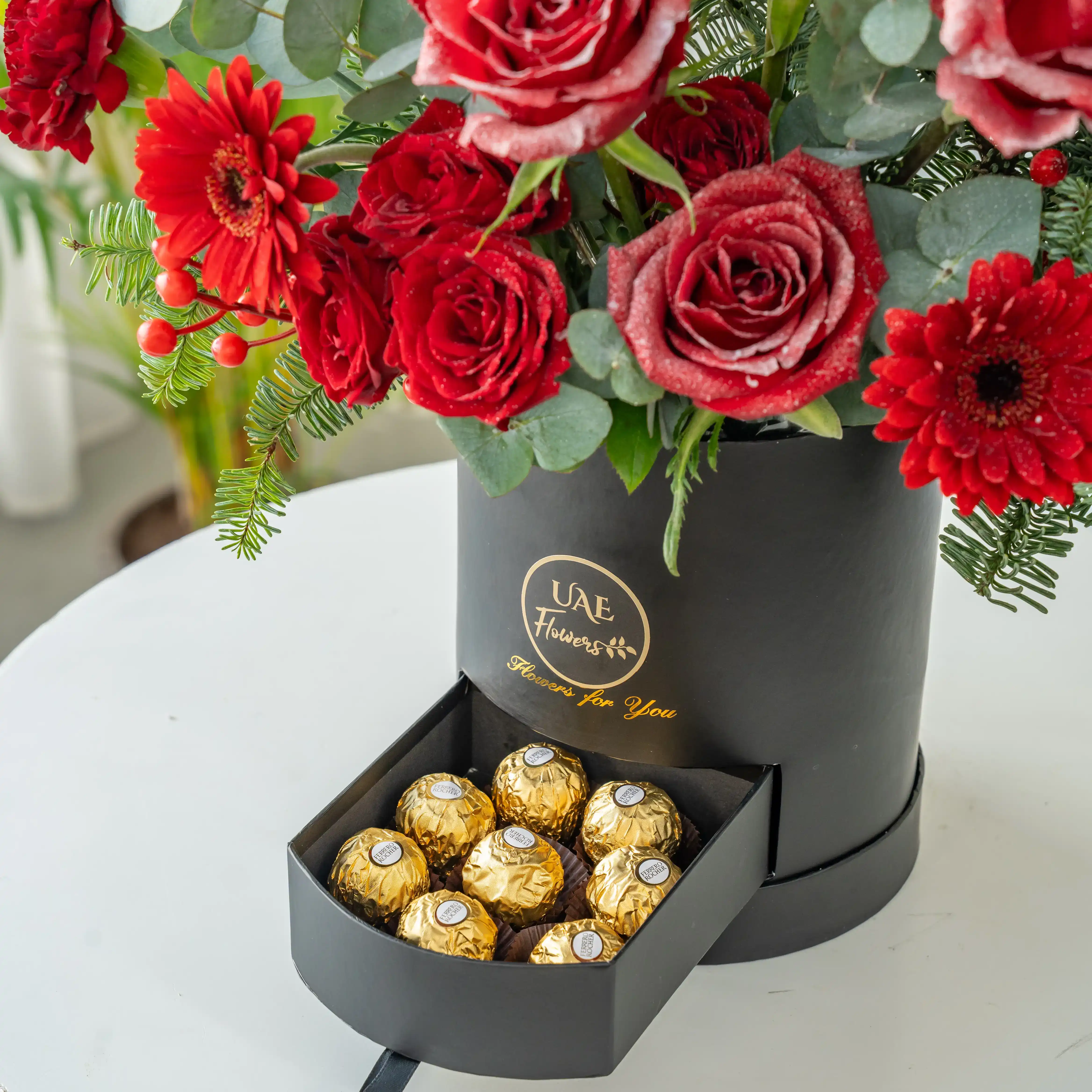Red rose and pine Christmas flower box with chocolates