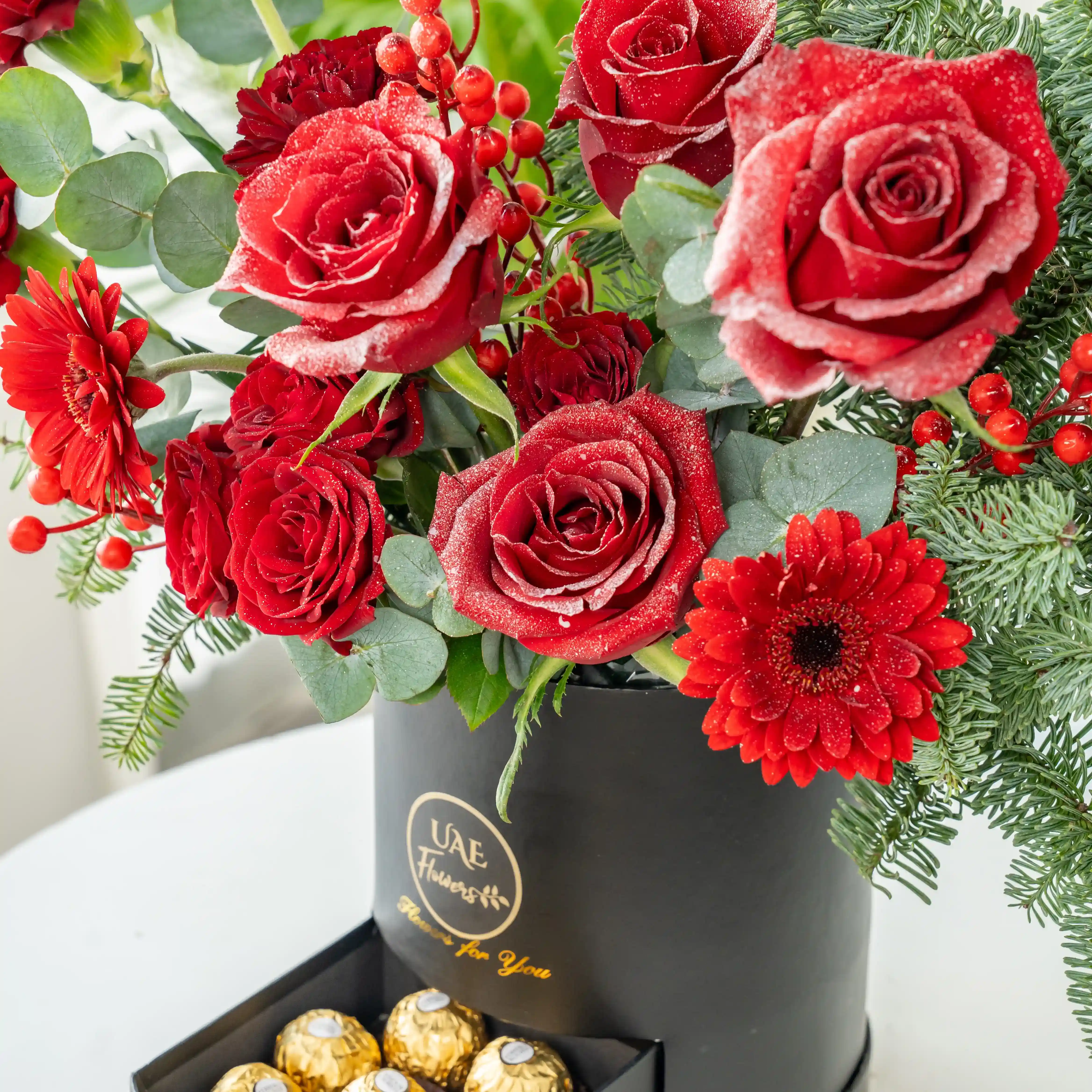 Red rose and pine Christmas flower box with chocolates