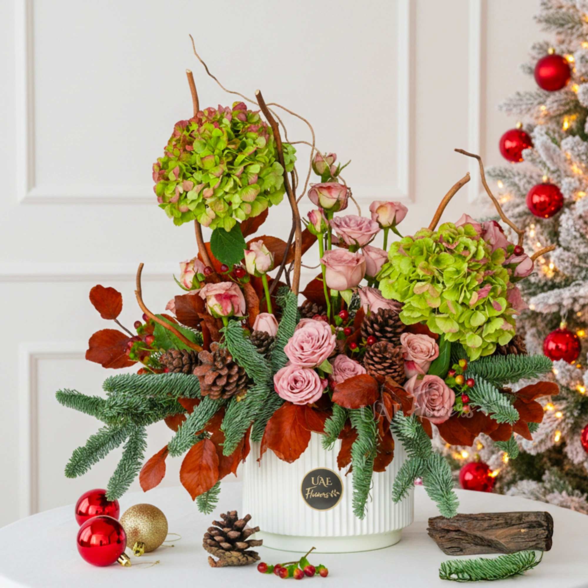 Emerald Ember Winter Garden with roses, pine, and hydrangeas in a festive planter