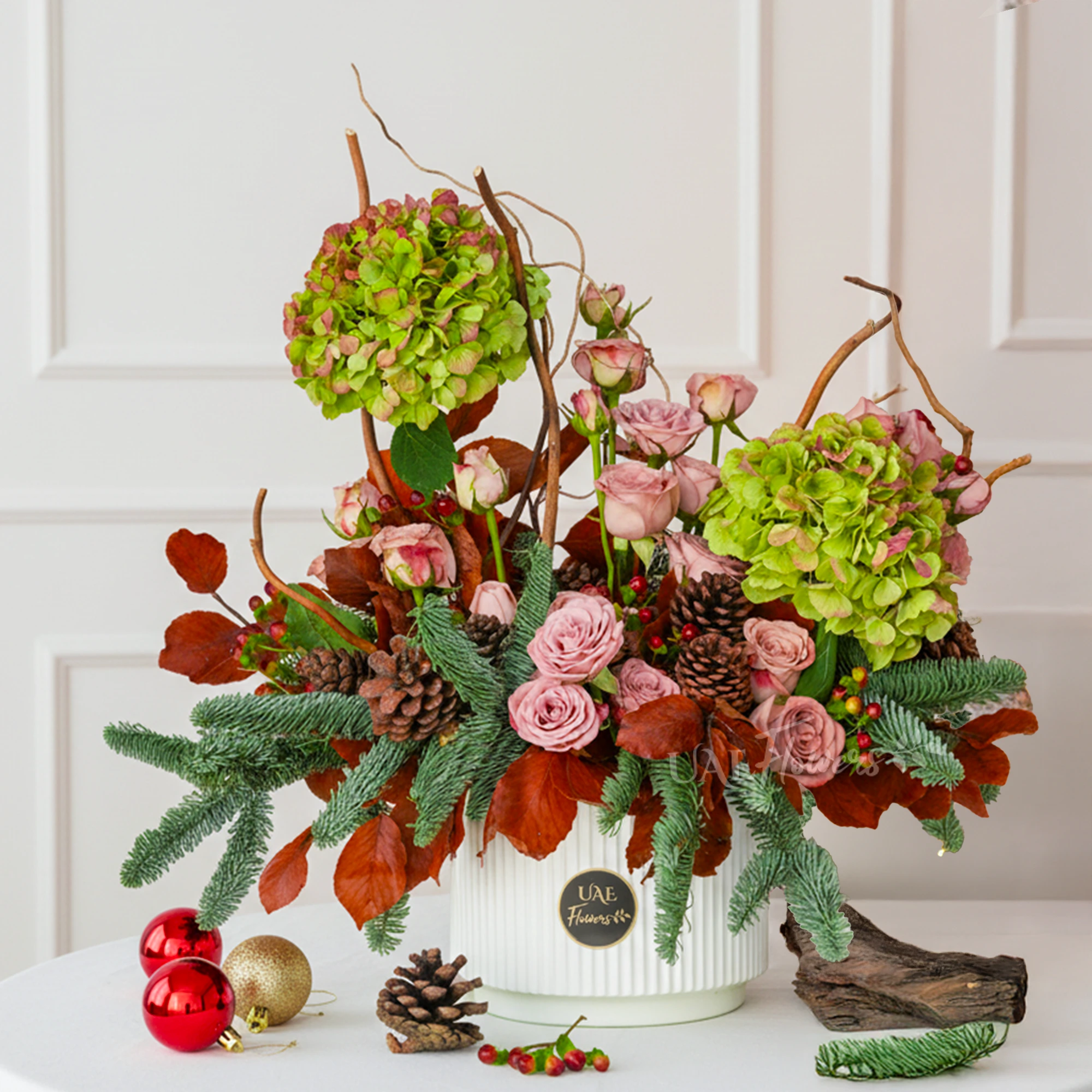 Emerald Ember Winter Garden with roses, pine, and hydrangeas in a festive planter