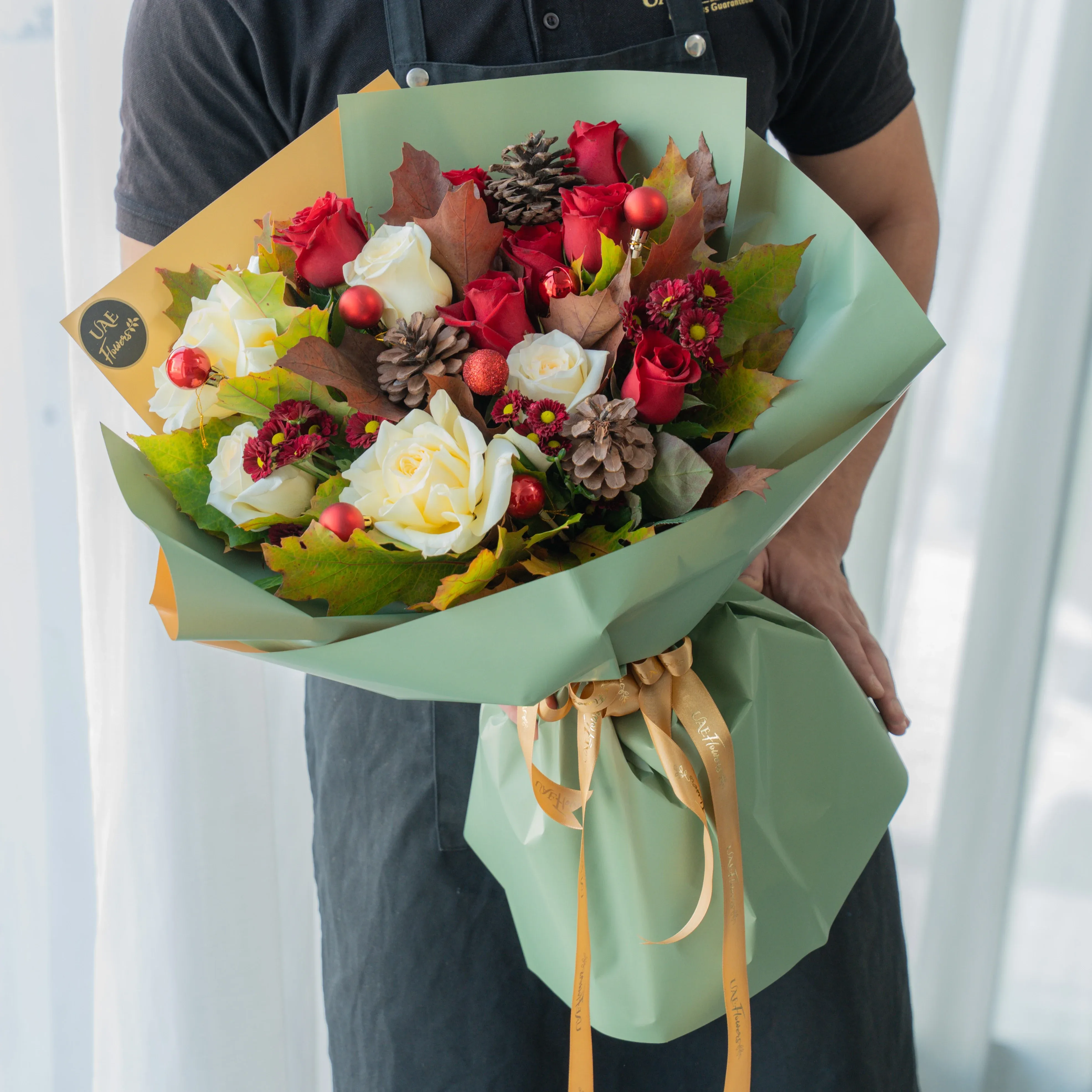 Festive red and white Christmas bouquet with pinecones and winter greens