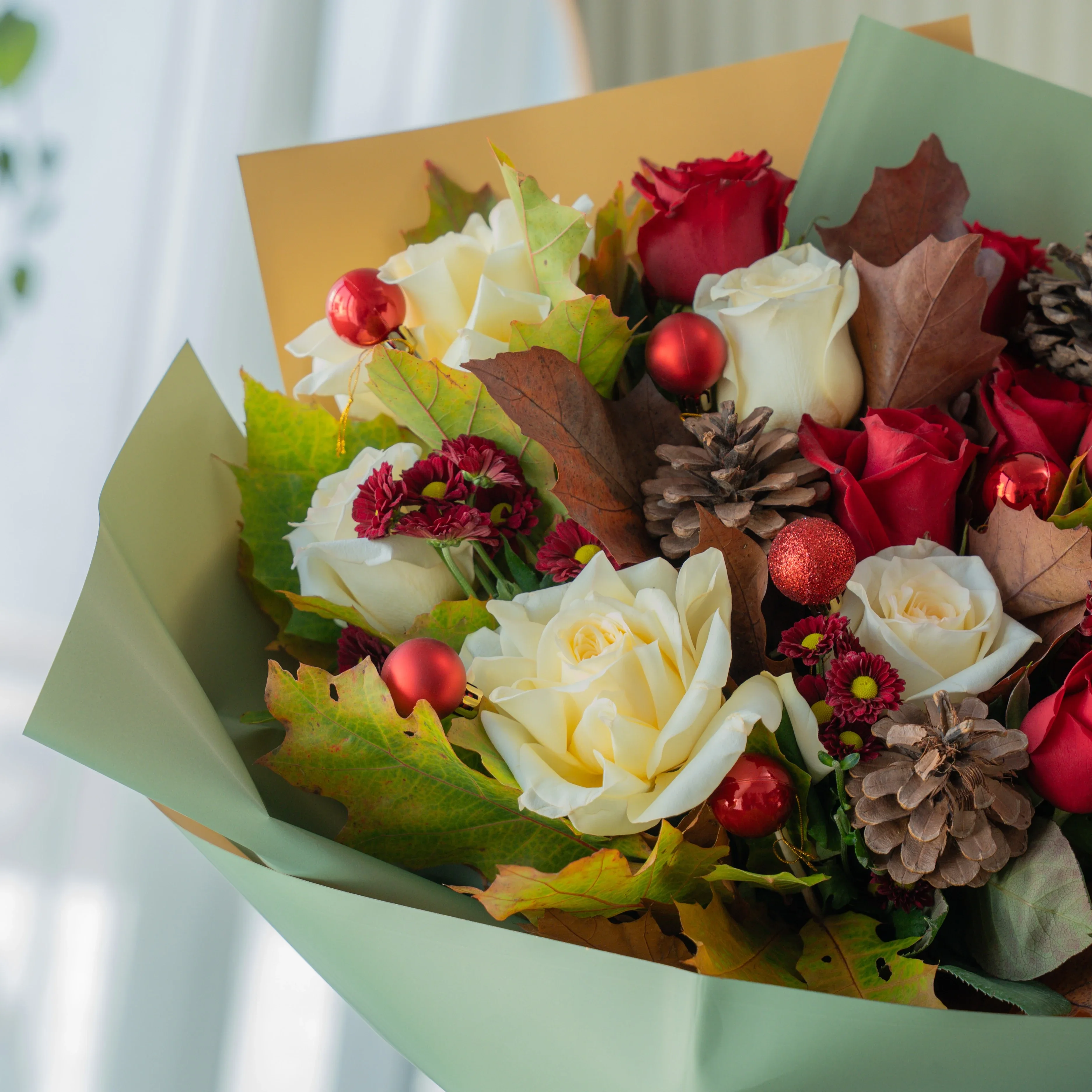 Festive red and white Christmas bouquet with pinecones and winter greens