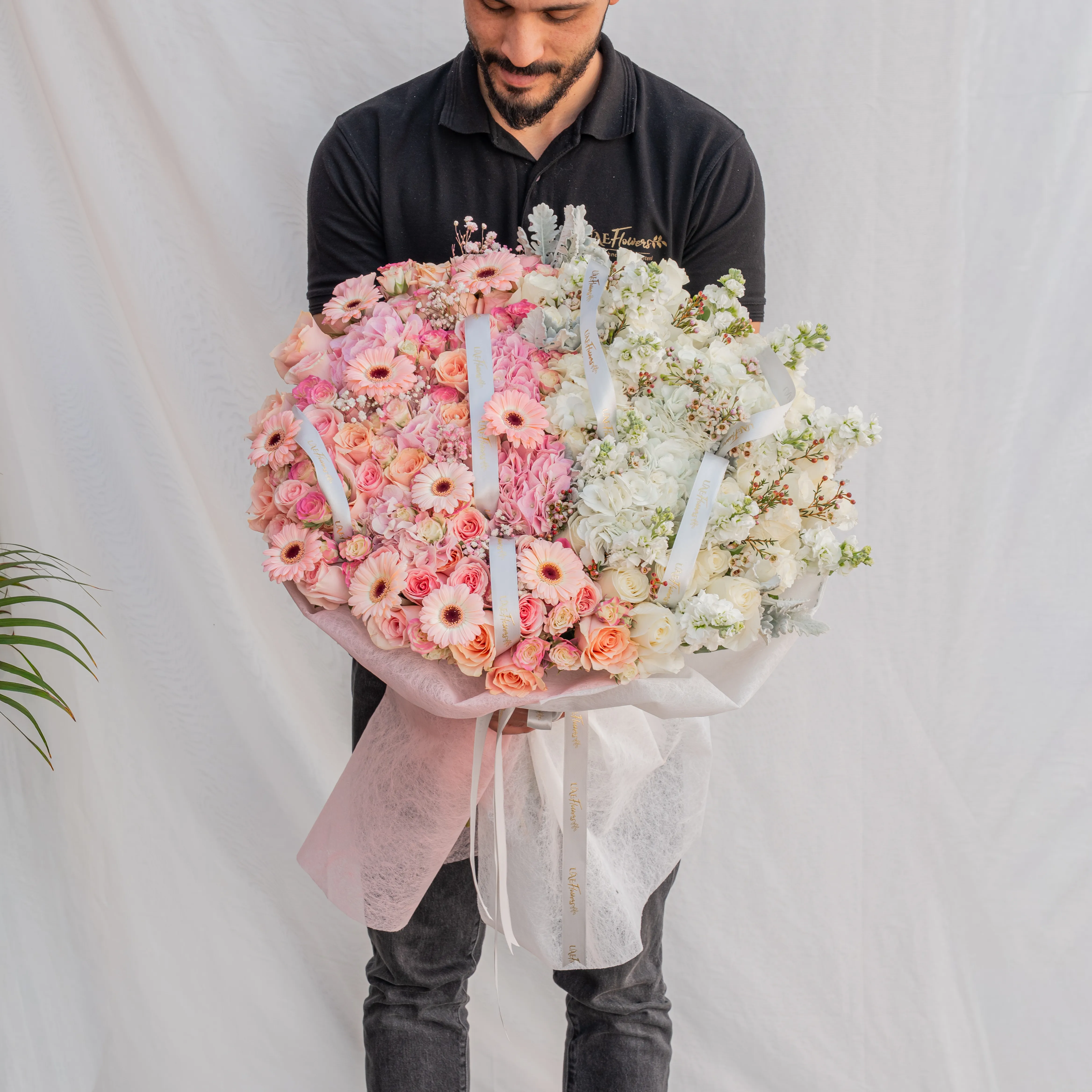 Bouquet of 4 pink hydrangeas, 30 pink roses, 10 pink spray roses, 10 pink gerberas, 3 white hydrangeas, 7 white matthiola and 30 white roses with pink & white wrapping paper and ribbon.