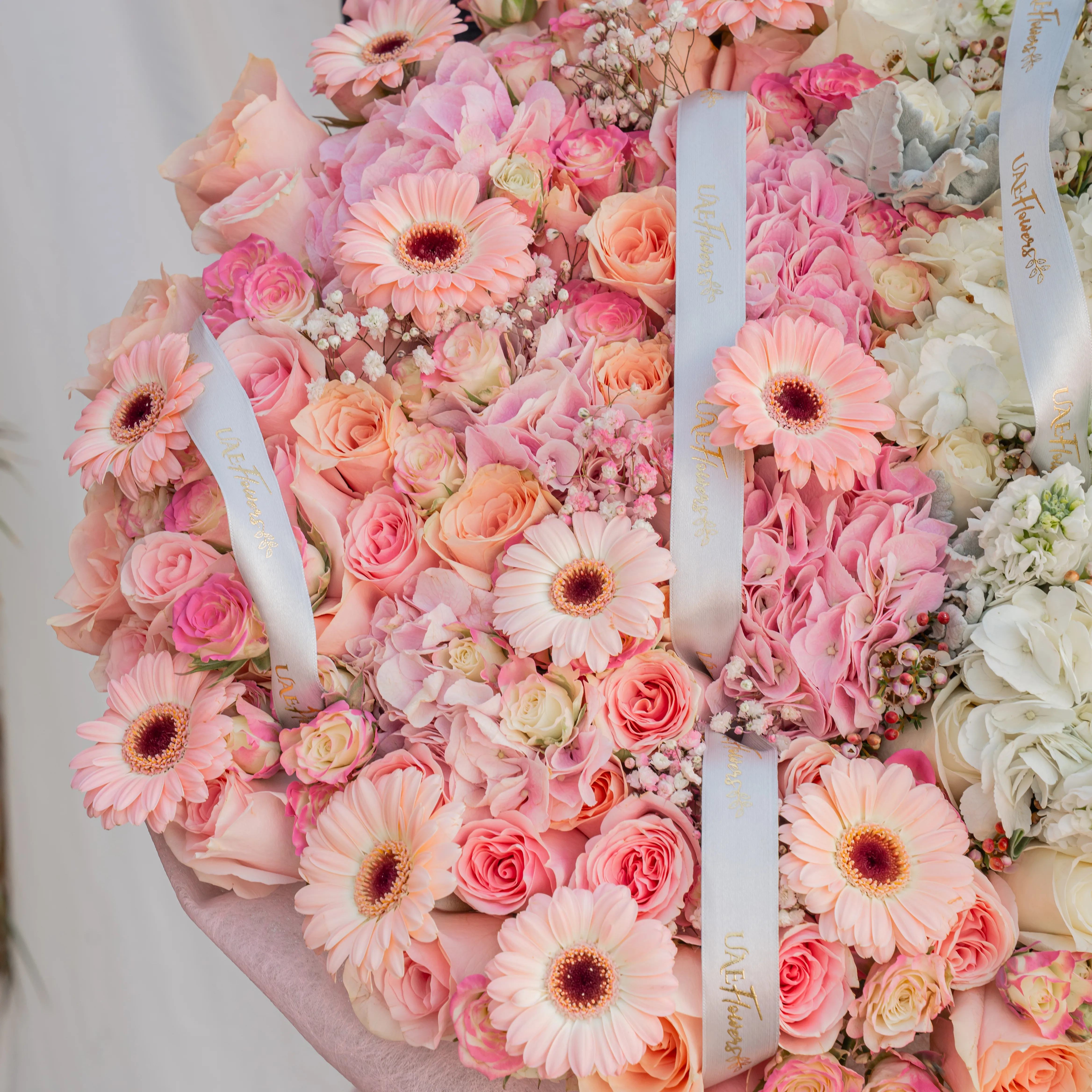 Bouquet of 4 pink hydrangeas, 30 pink roses, 10 pink spray roses, 10 pink gerberas, 3 white hydrangeas, 7 white matthiola and 30 white roses with pink & white wrapping paper and ribbon.