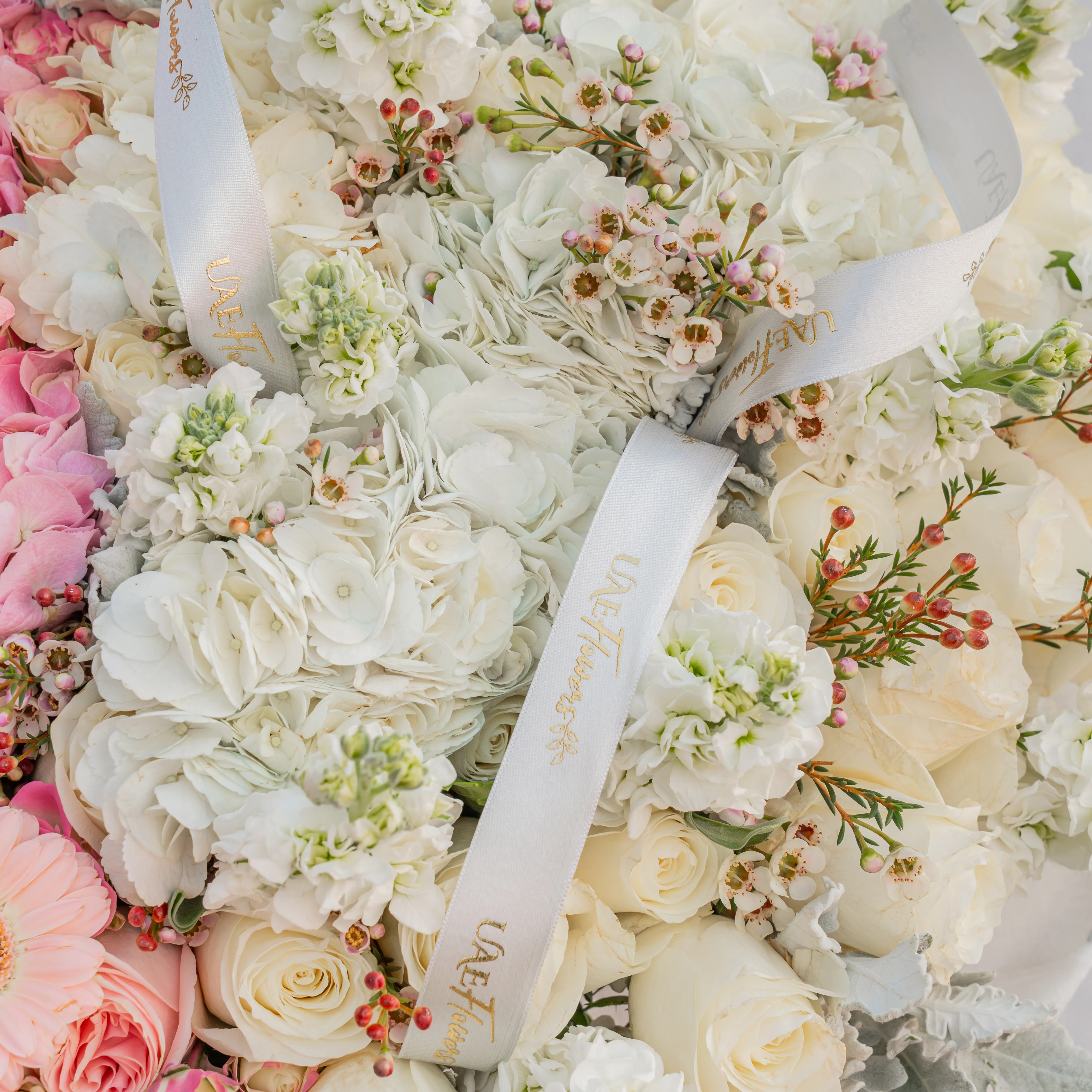 Bouquet of 4 pink hydrangeas, 30 pink roses, 10 pink spray roses, 10 pink gerberas, 3 white hydrangeas, 7 white matthiola and 30 white roses with pink & white wrapping paper and ribbon.