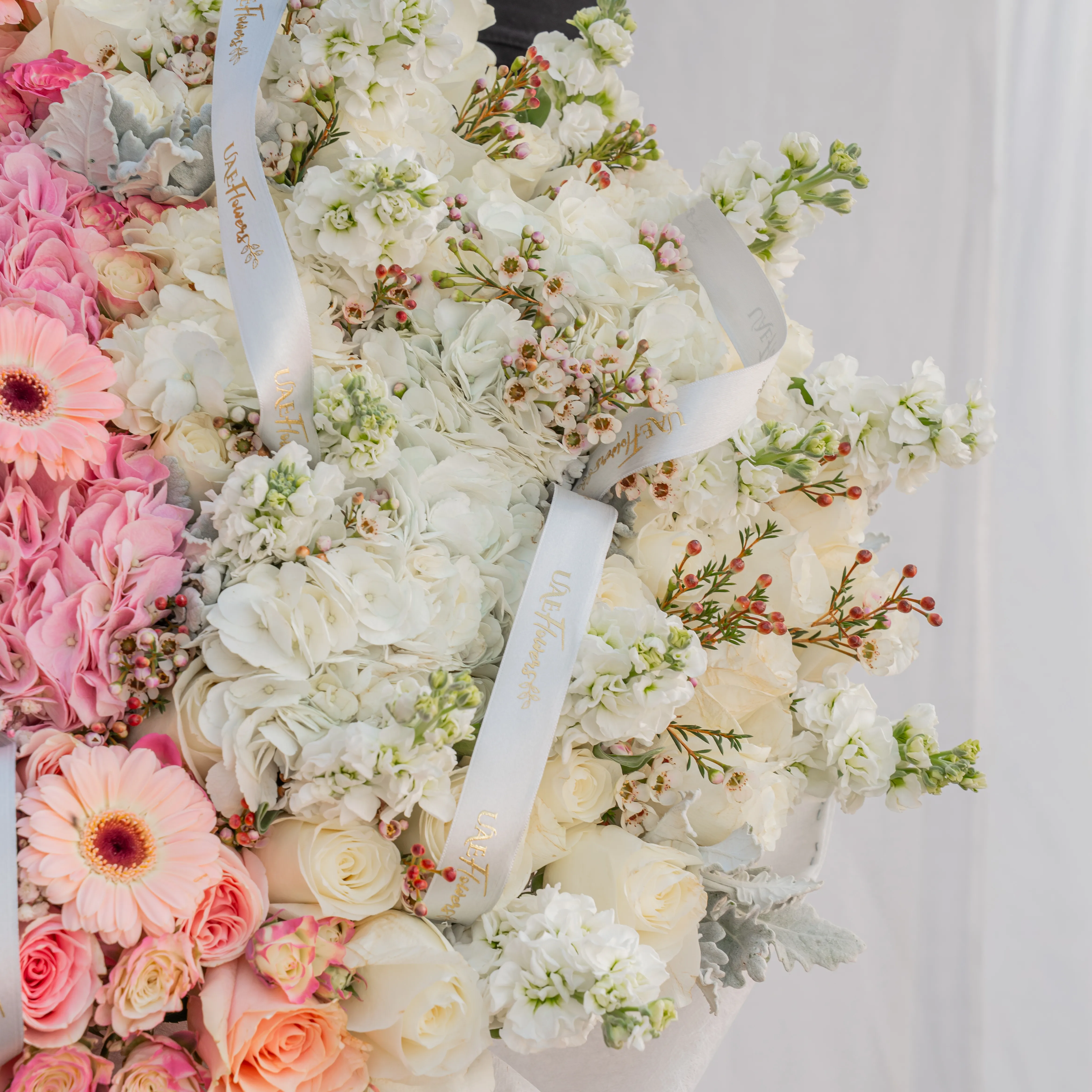 Bouquet of 4 pink hydrangeas, 30 pink roses, 10 pink spray roses, 10 pink gerberas, 3 white hydrangeas, 7 white matthiola and 30 white roses with pink & white wrapping paper and ribbon.