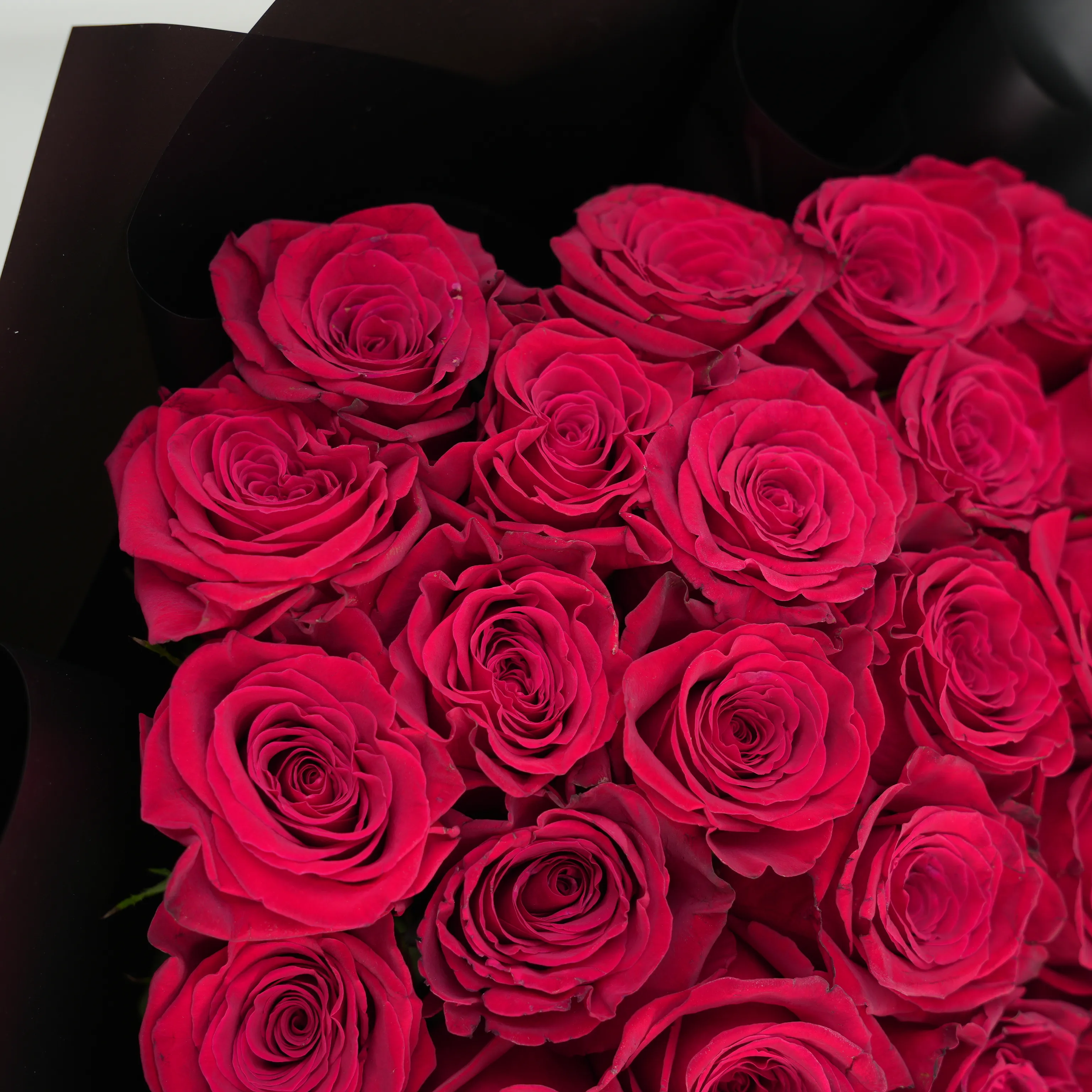 30 red roses with green fillers in black wrapping with Love For You Paper tied with black ribbons.