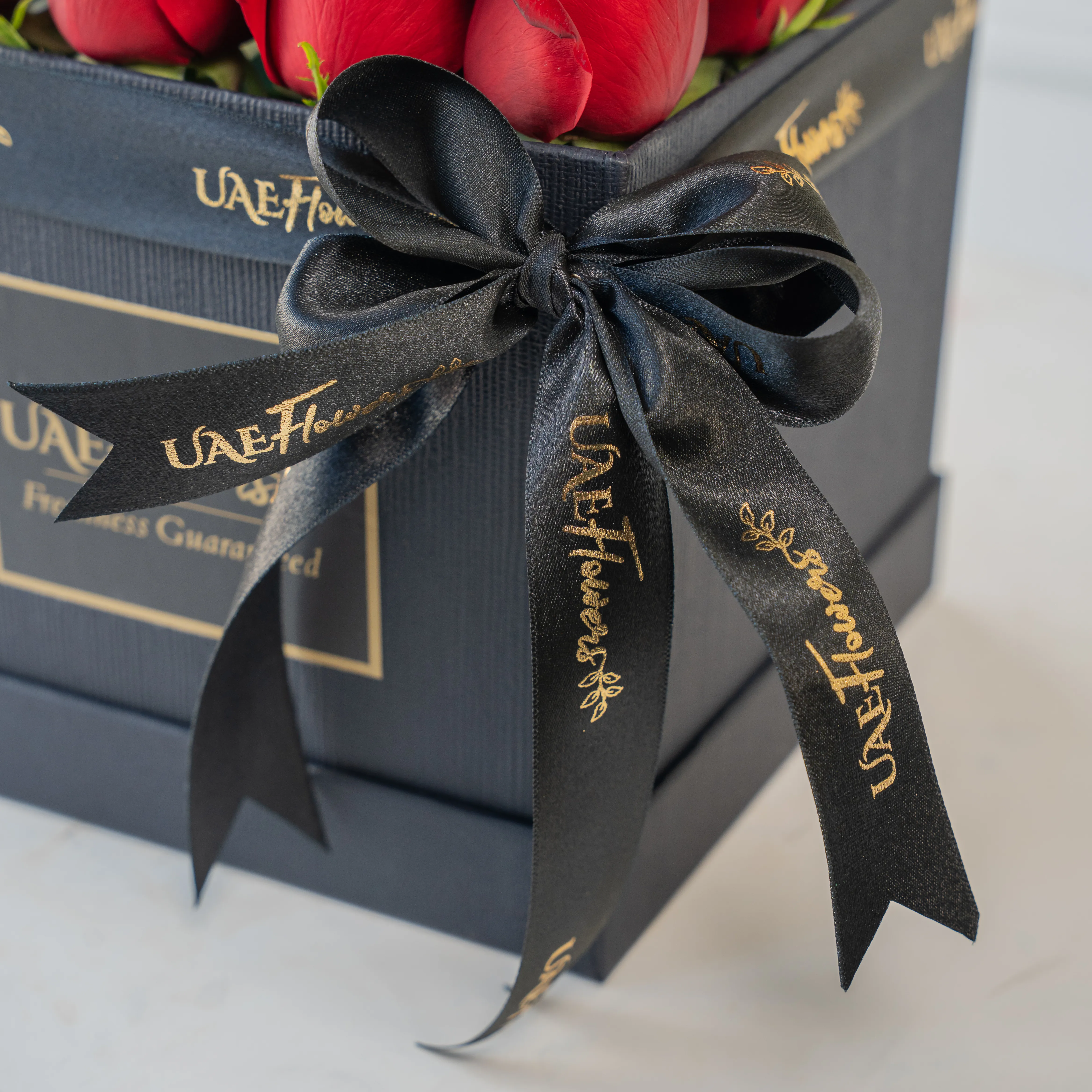 25 red roses in a square box.