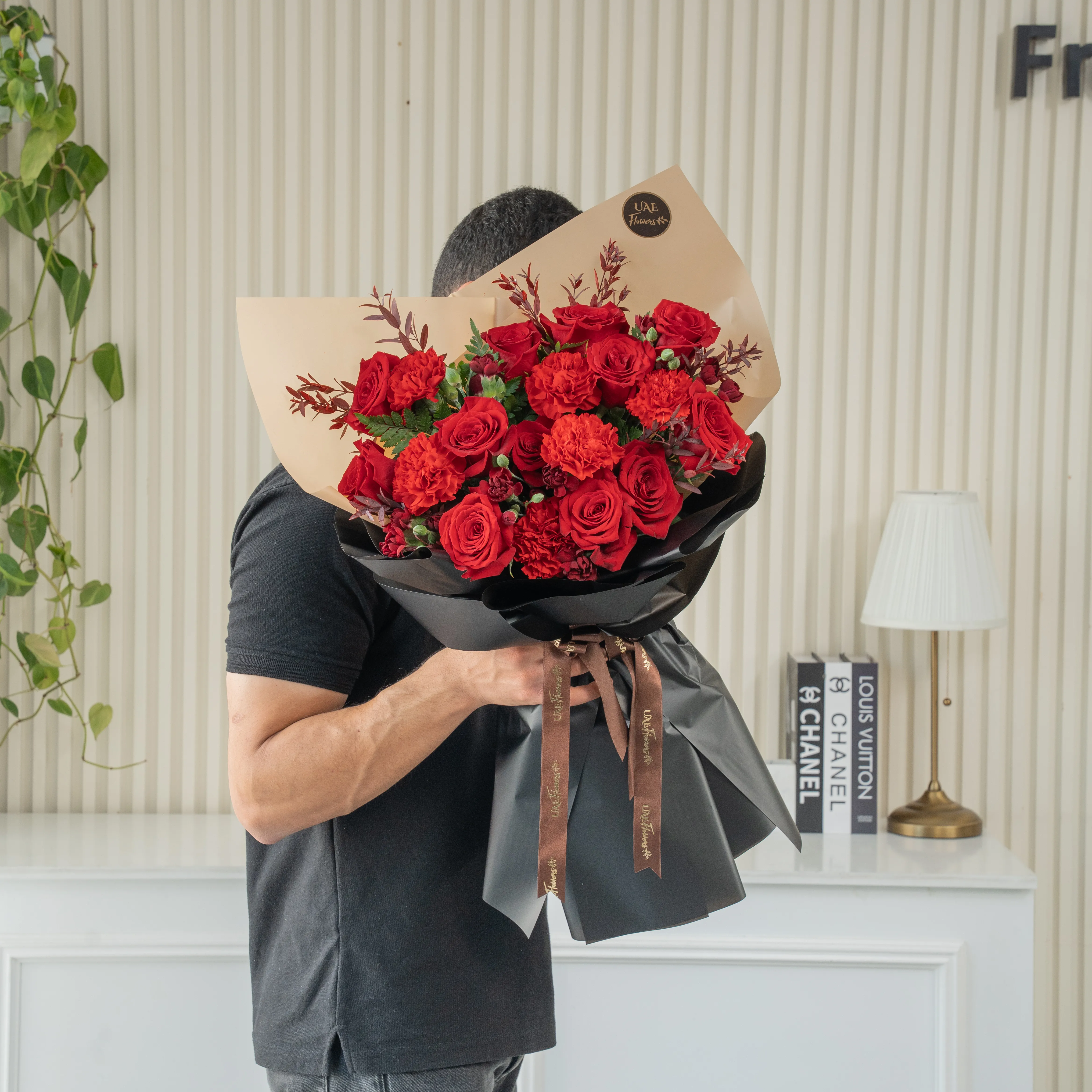 Bouquet of 12 red roses, 6 red carnations with green fillers in nice paper packing.