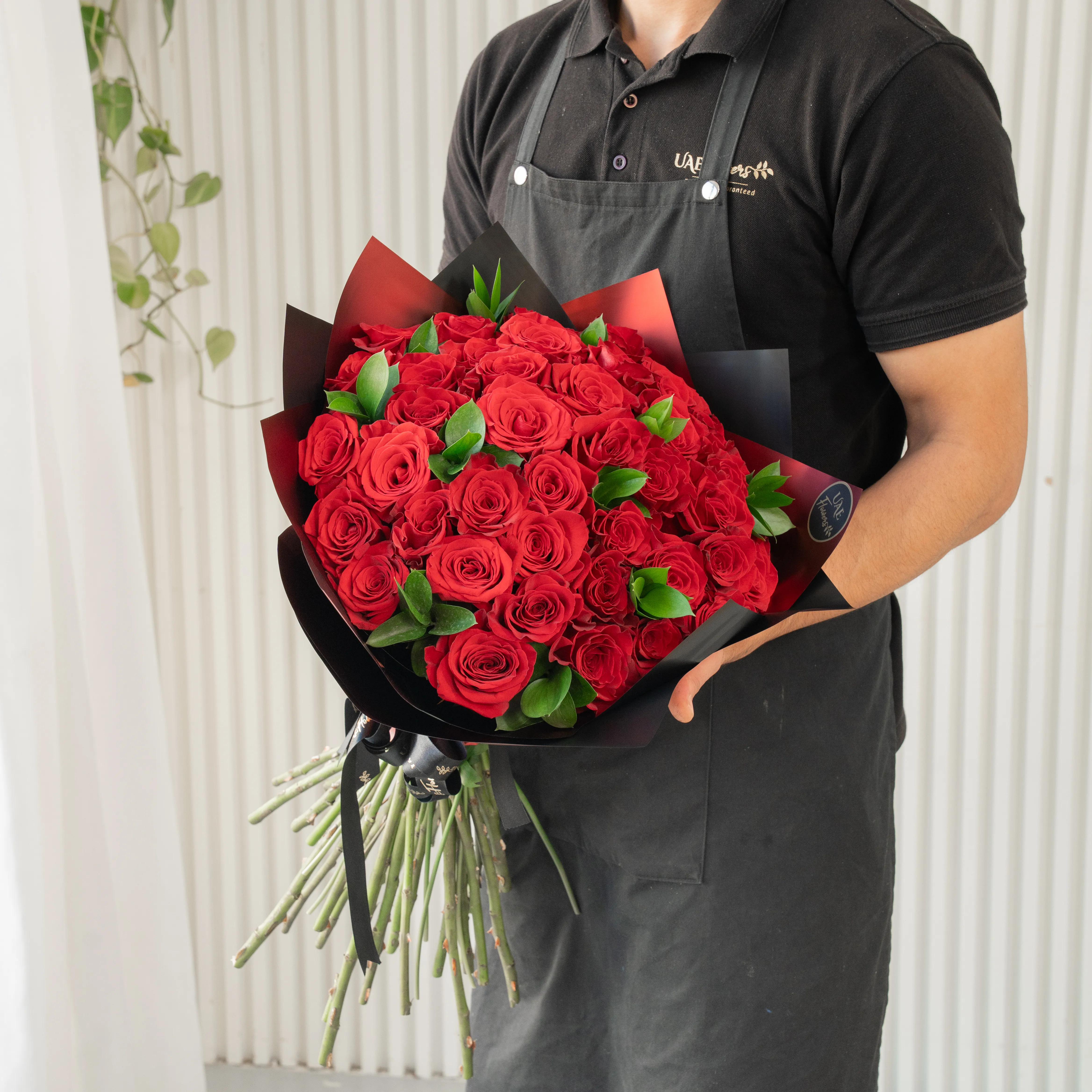 40 red roses wrapped in premium paper and tied with ribbon