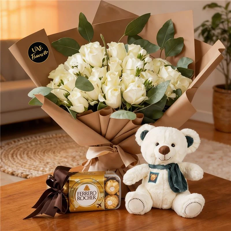 20 white roses with green fillers in brown wrapping tied with ribbons, small white teddy bear and 16pcs of Ferrero rocher chocolate.