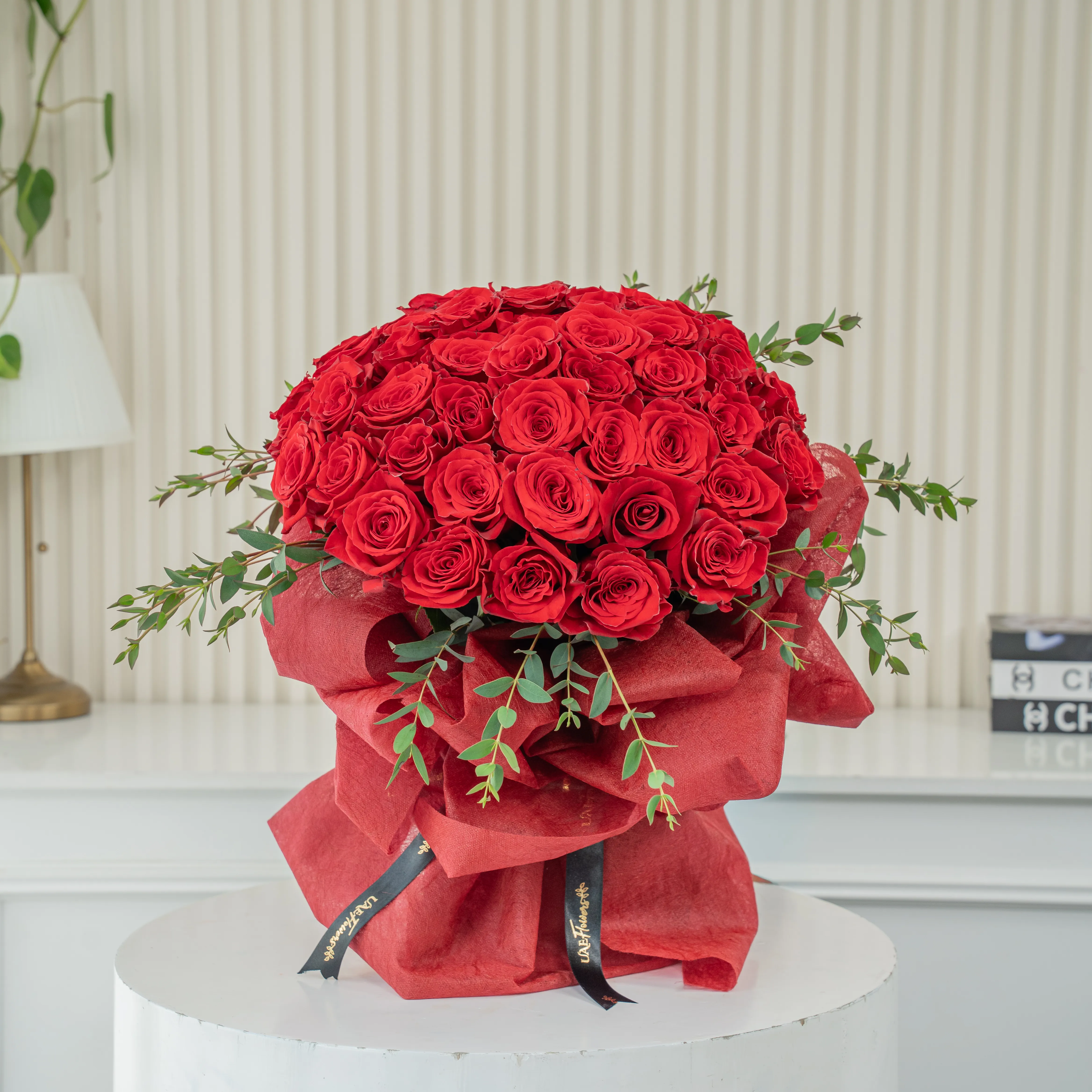 Bouquet of 40 Red Roses with green fillers in red wrapping.