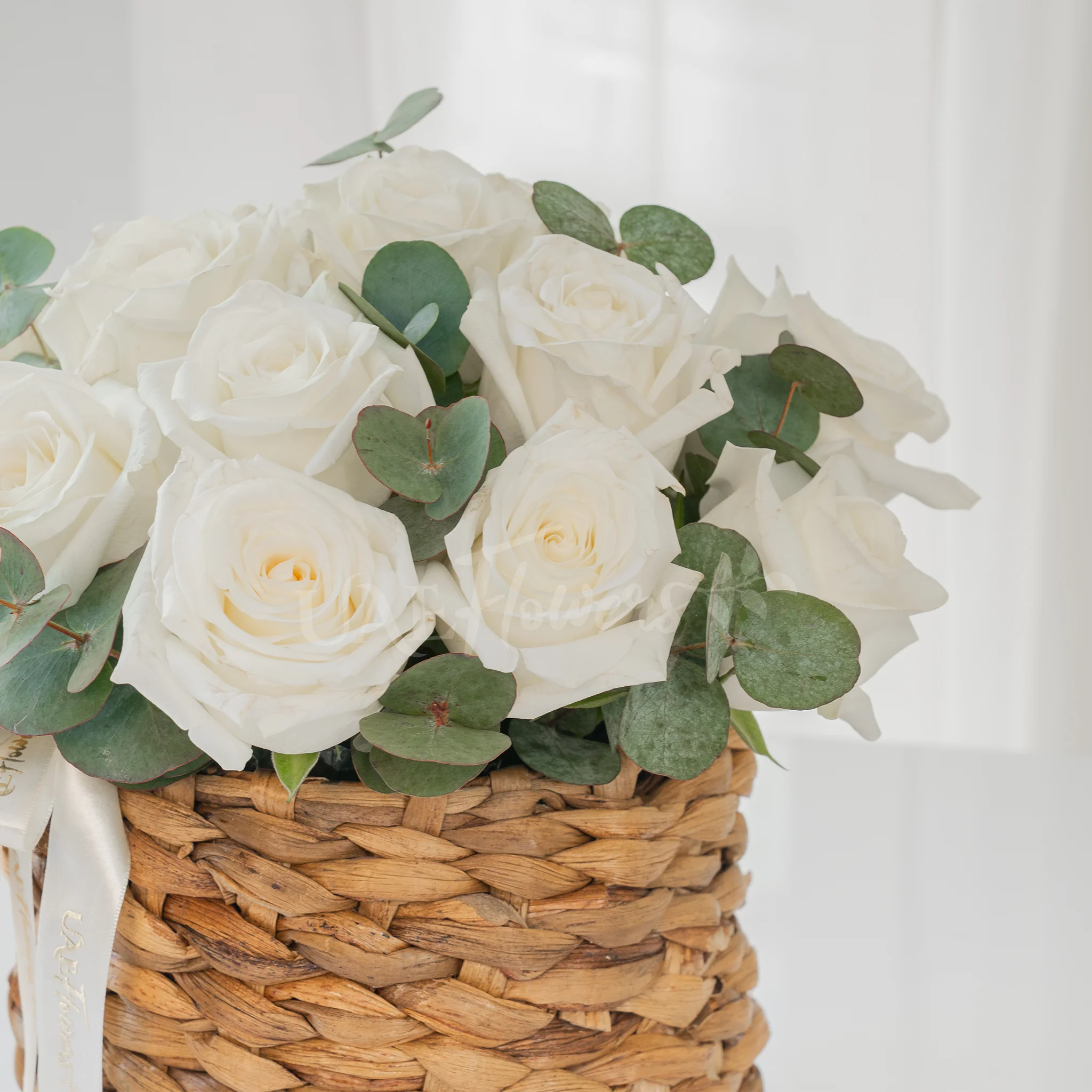 12 White Roses in a Round Basket