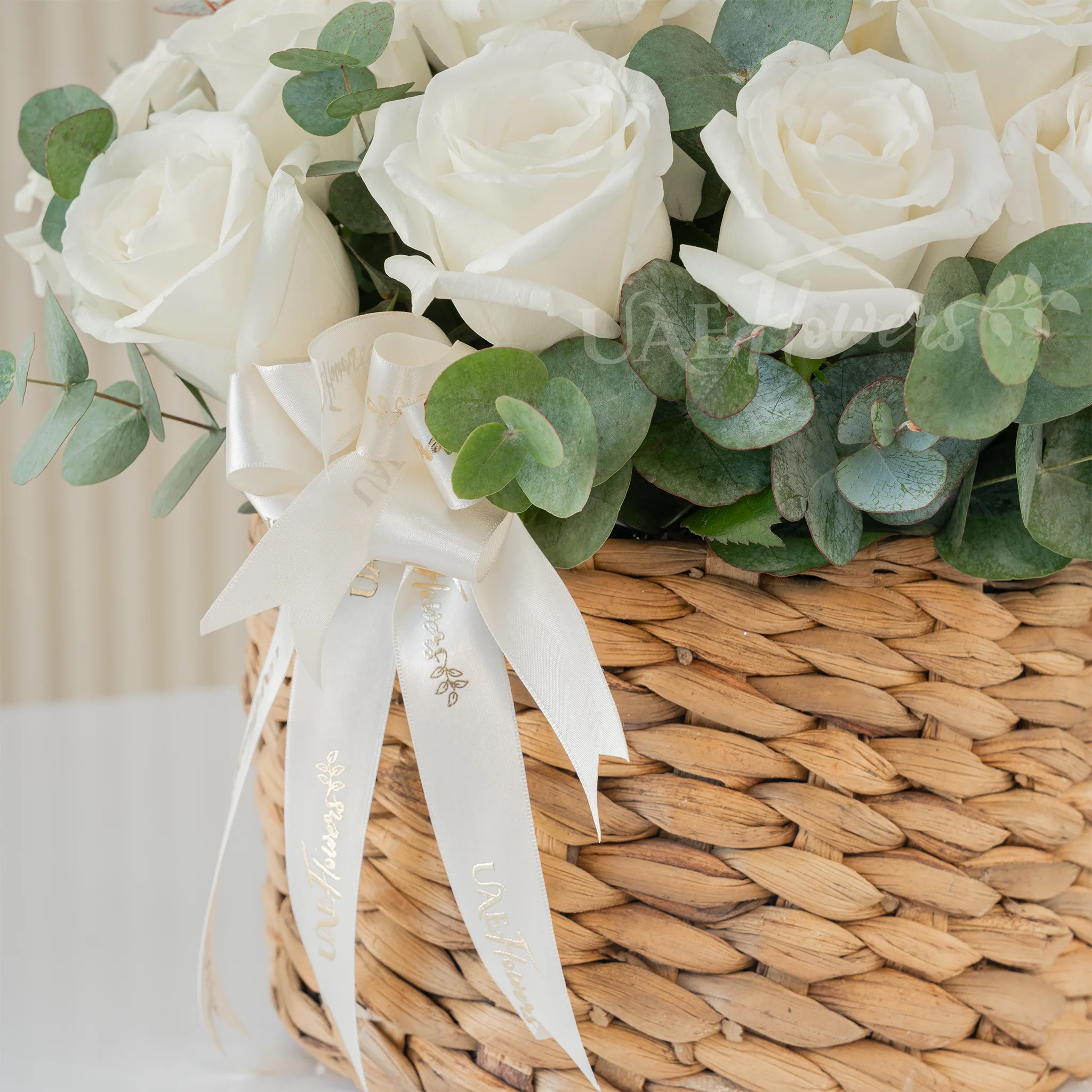12 White Roses in a Round Basket