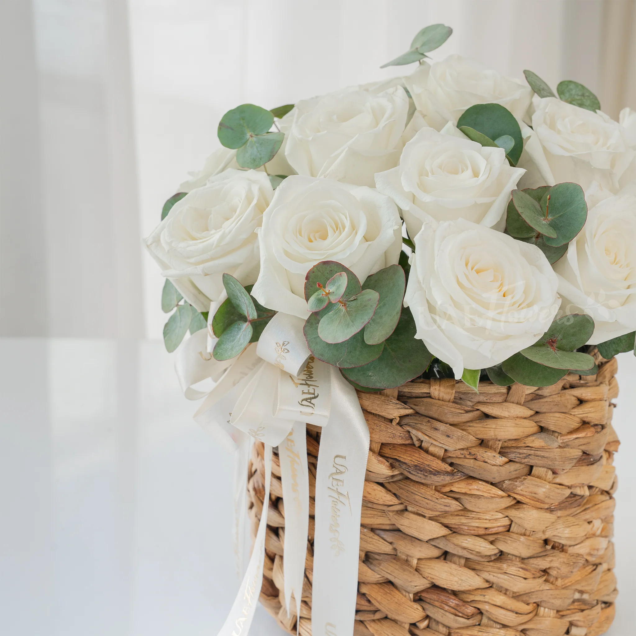 12 White Roses in a Round Basket