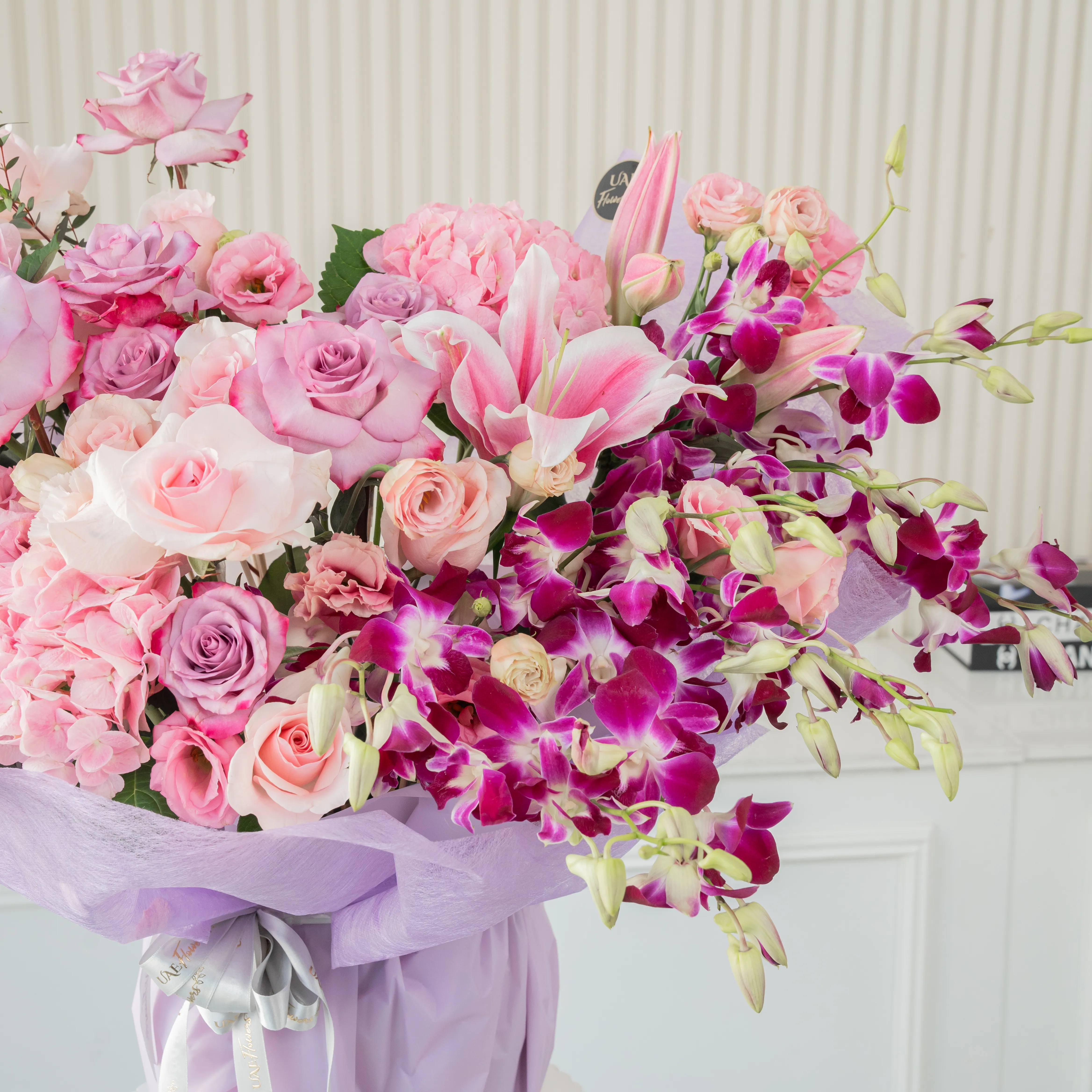 bouquet with pink, lilies, roses, hydrangeas, purple orchids