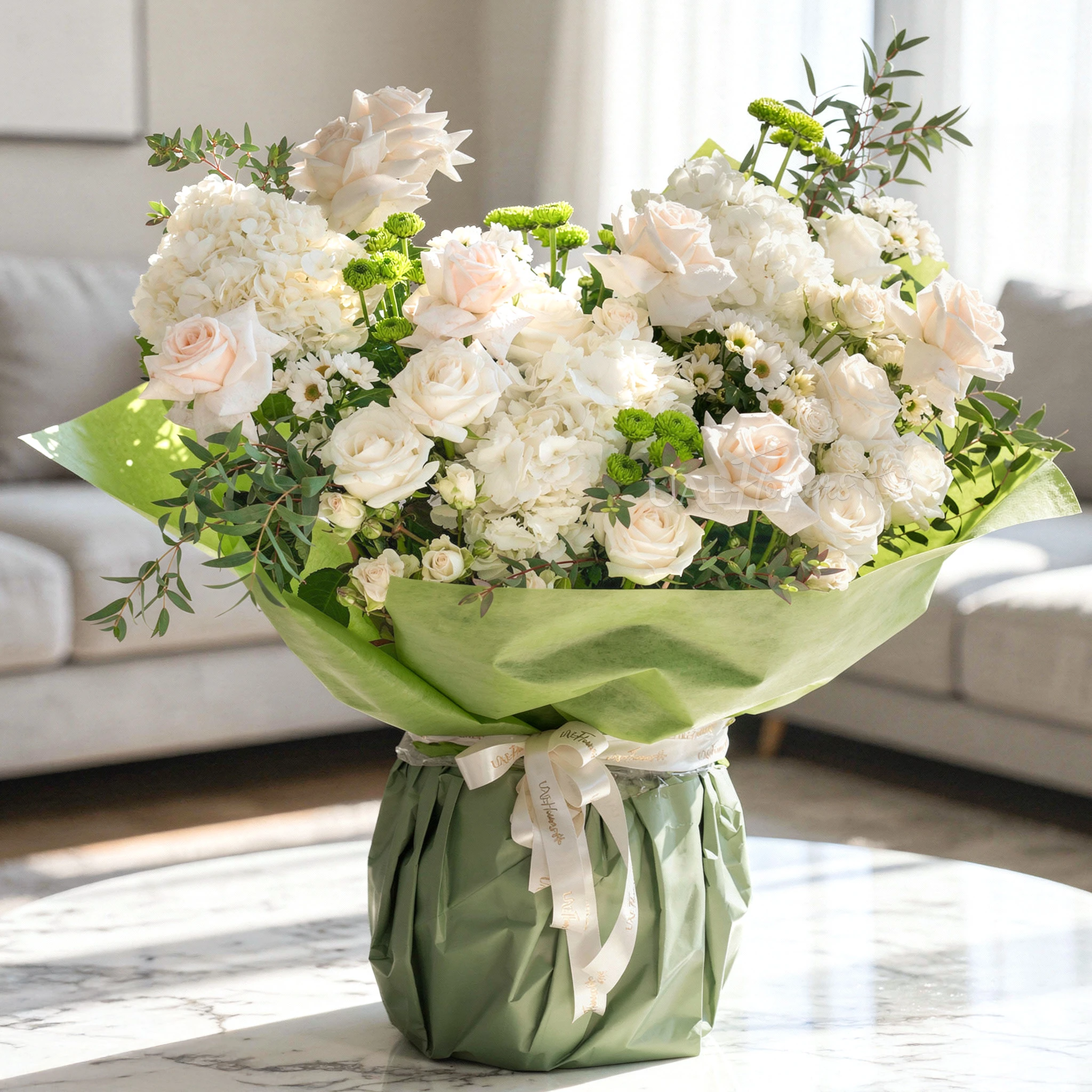 White Meadow bouquet with 16 white roses, 4 green chrysanthemums, and hydrangeas, tied with white ribbon—perfect for celebrations or thoughtful gifting.