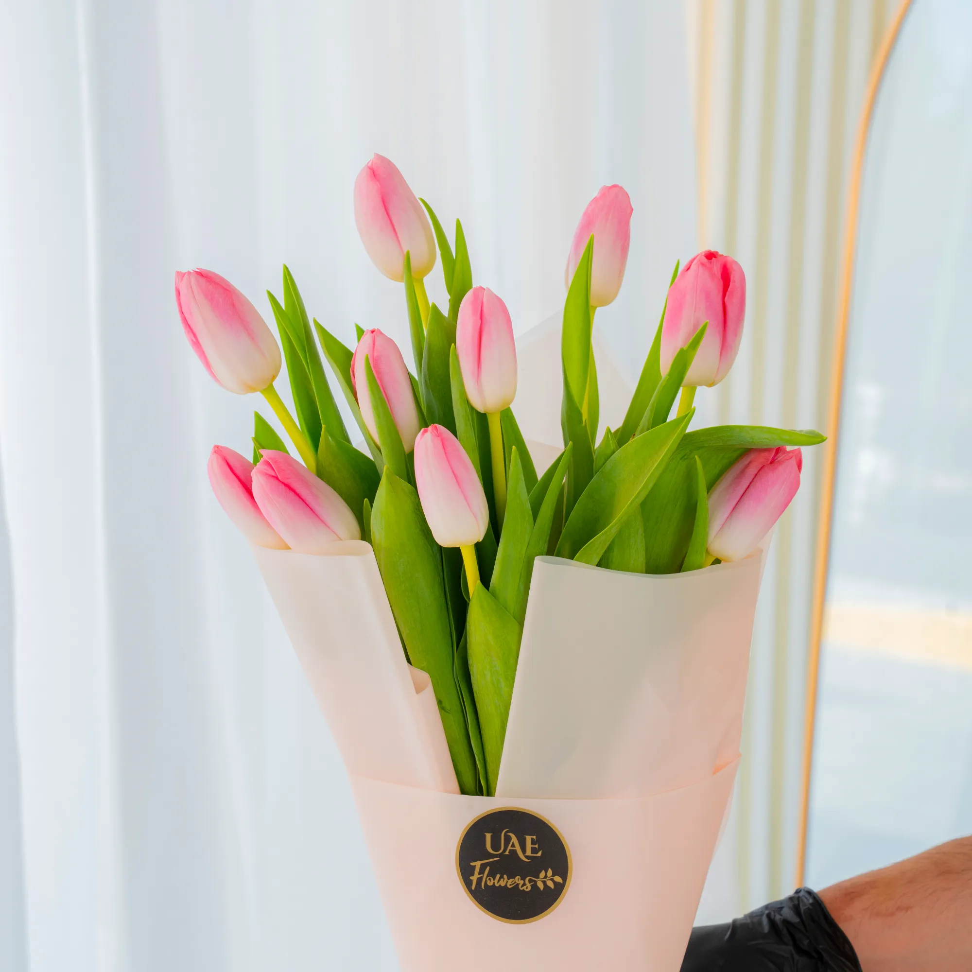 10 pink tulips is wrapped in stylish pink paper