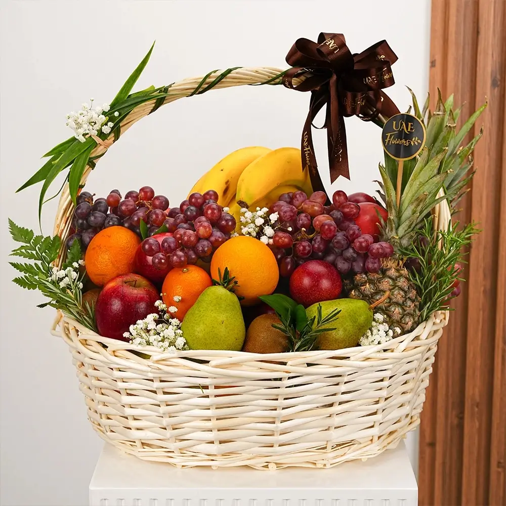 Basket arrangement of sweet pineapple, oranges, apples, pears, grapes, and kiwis nicely arranged with baby's breath and greens, tie a brown ribbon on the handle