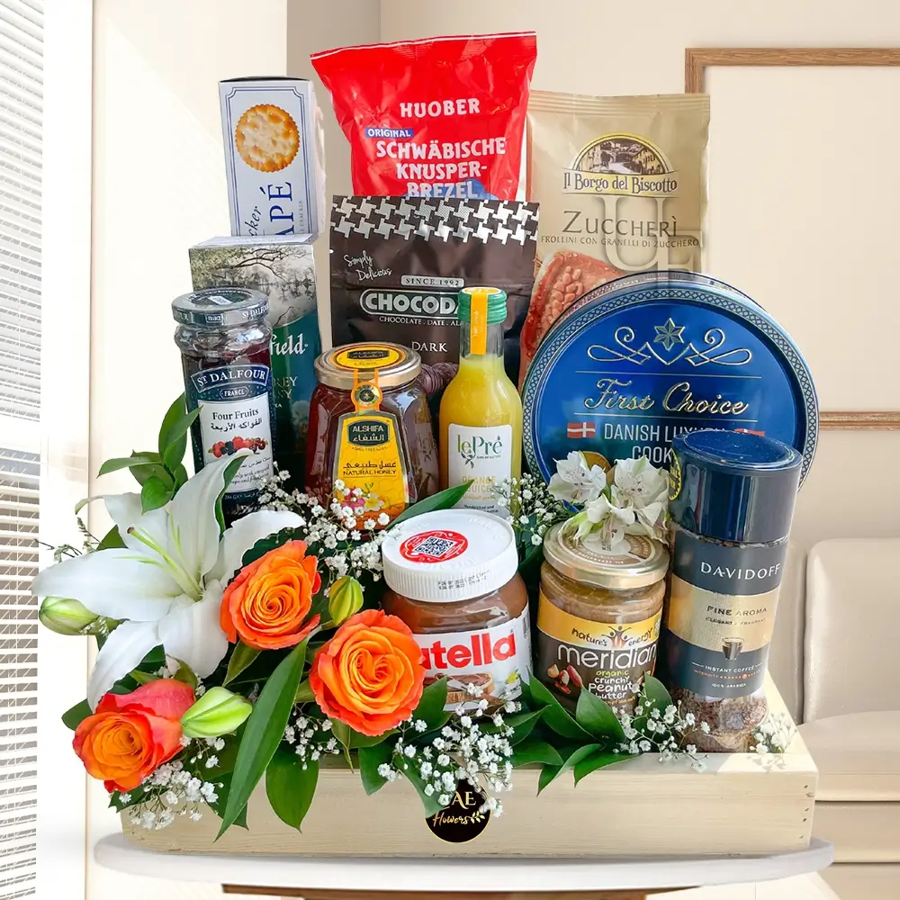 breakfast hamper with snacks, tea, coffee, jam, honey, Nutella, and fresh flowers