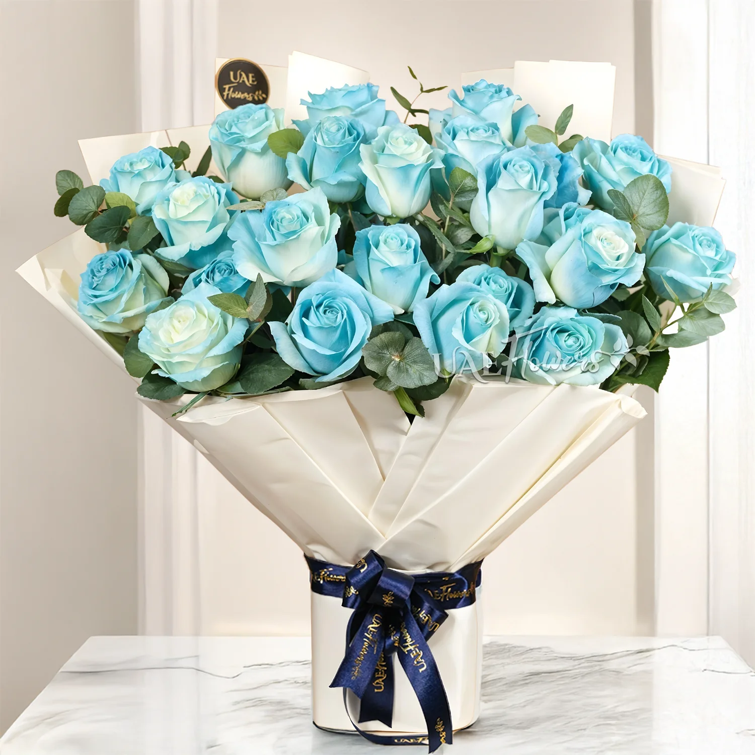 25 blue sprayed roses with green fillers and ribbon wrapping