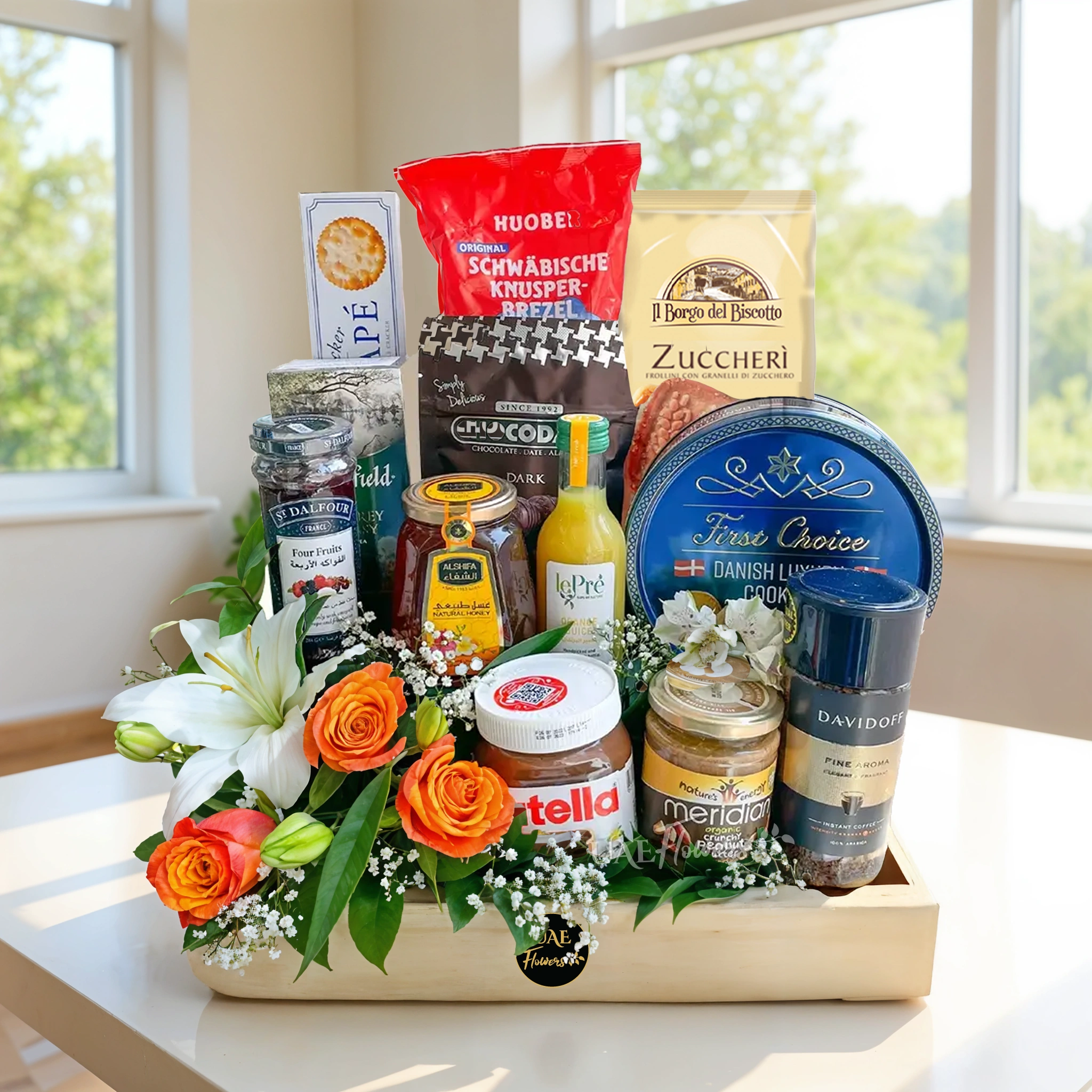 breakfast hamper with snacks, tea, coffee, jam, honey, Nutella, and fresh flowers