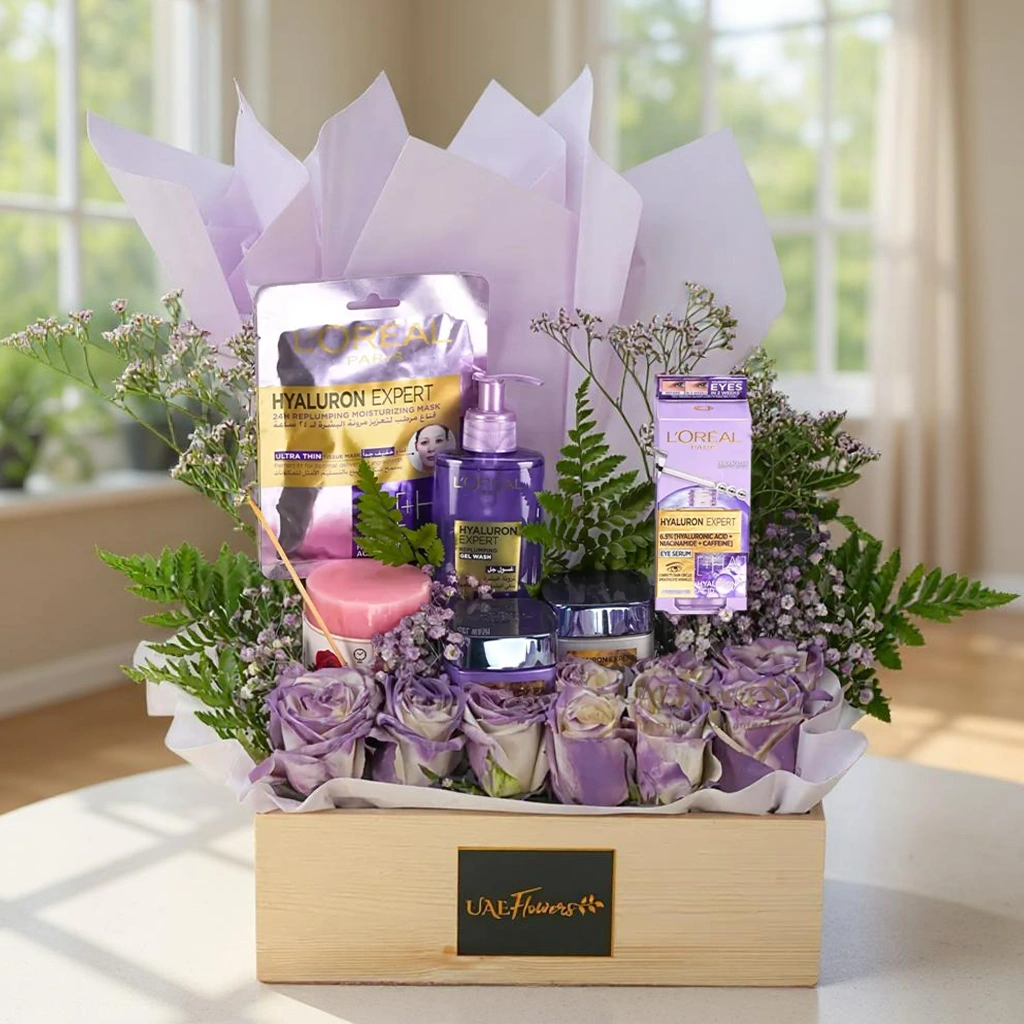 L'Oreal eye serum, day and night creams, face wash, a pink pillar candle, 10 white roses with purple spray