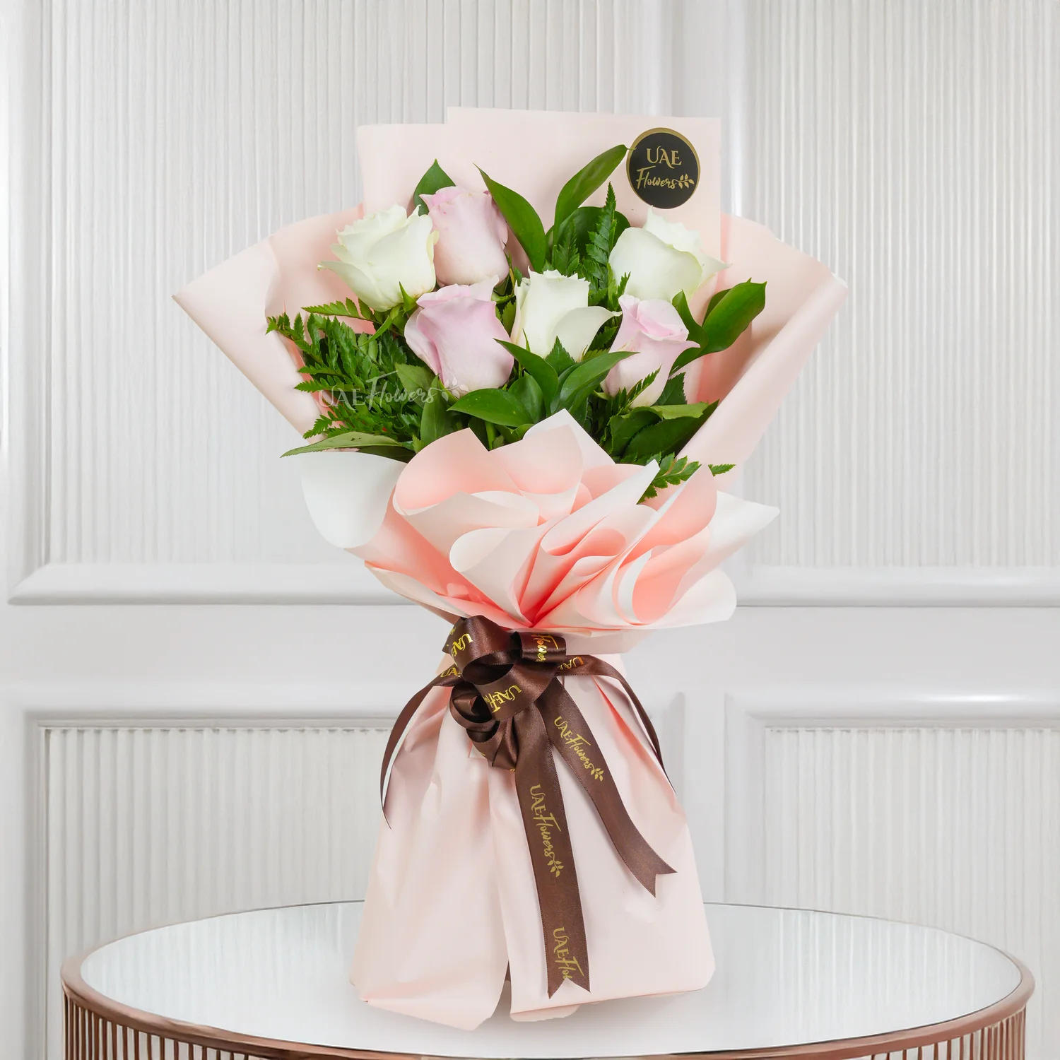 Bouquet of 6 white and pink roses with green fillers in nice wrapping, a small brown teddy bear and 1 kg black forest cake.