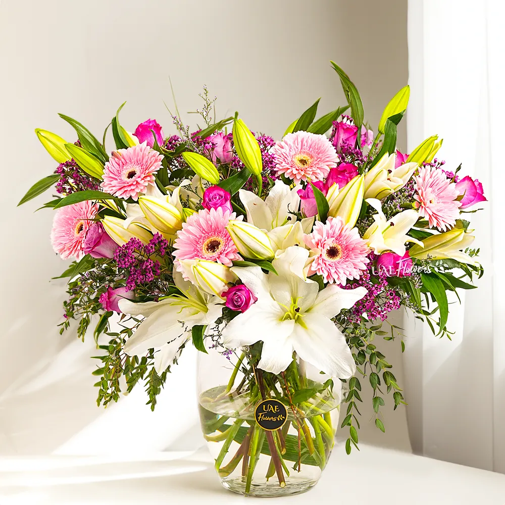 lilies and roses flower arrangement, graceful roseate bouquet UAE, glass vase floral display, pink gerbera and purple rose combo, elegant flower delivery Dubai