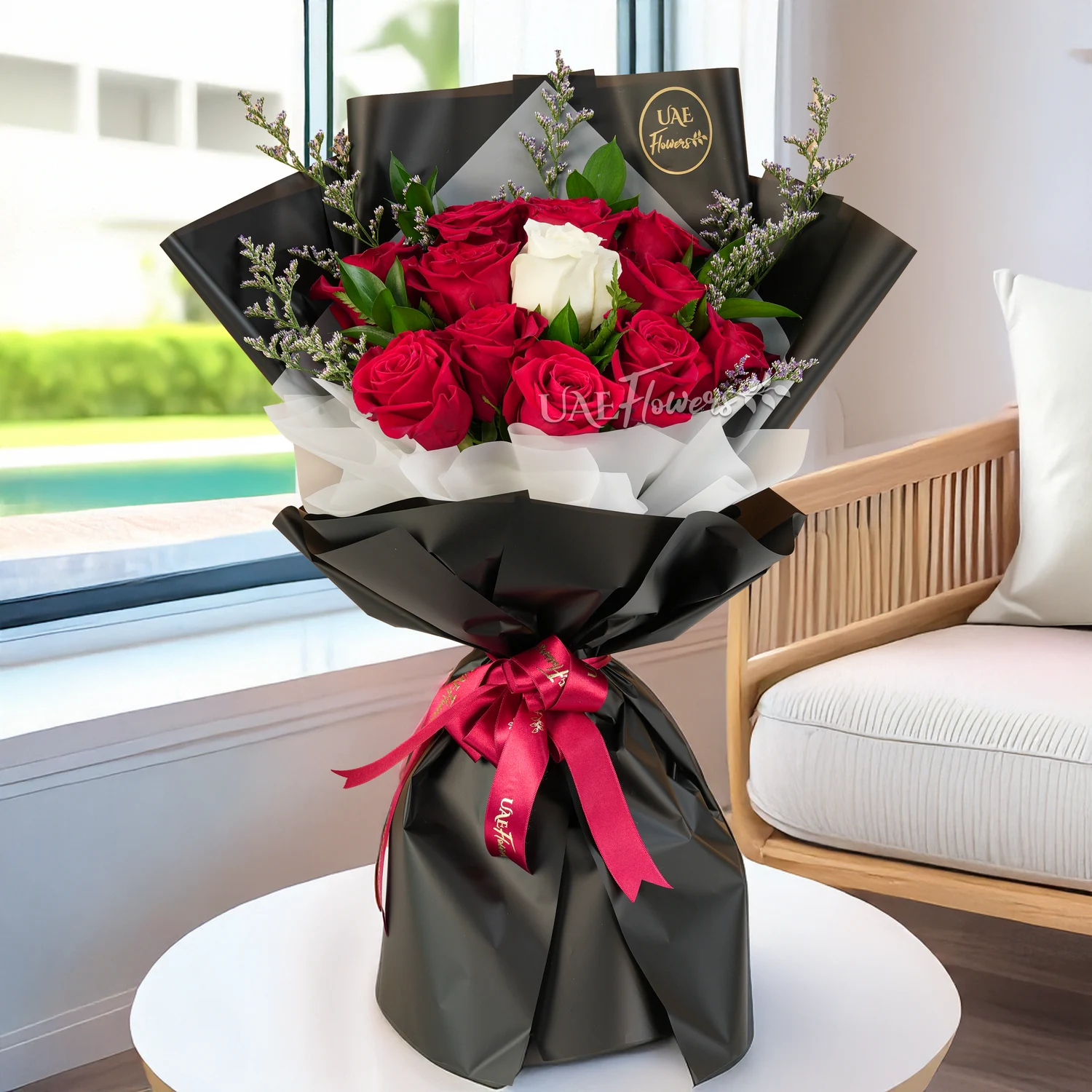 Bouquet of 12 red roses and 1 white rose in center with green fillers in nice paper packing with ribbons, 1 kg fruit cake and a small white teddy bear.