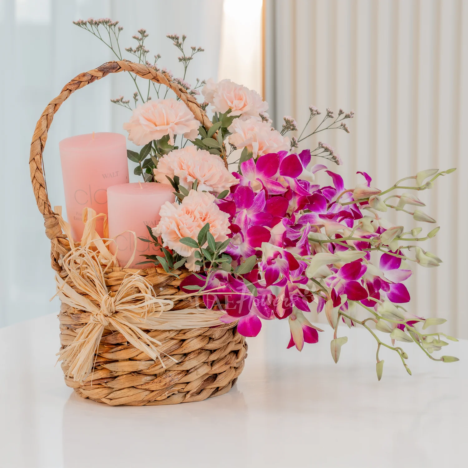 10 purple orchids, 5 pink carnations, 2 pink candles,