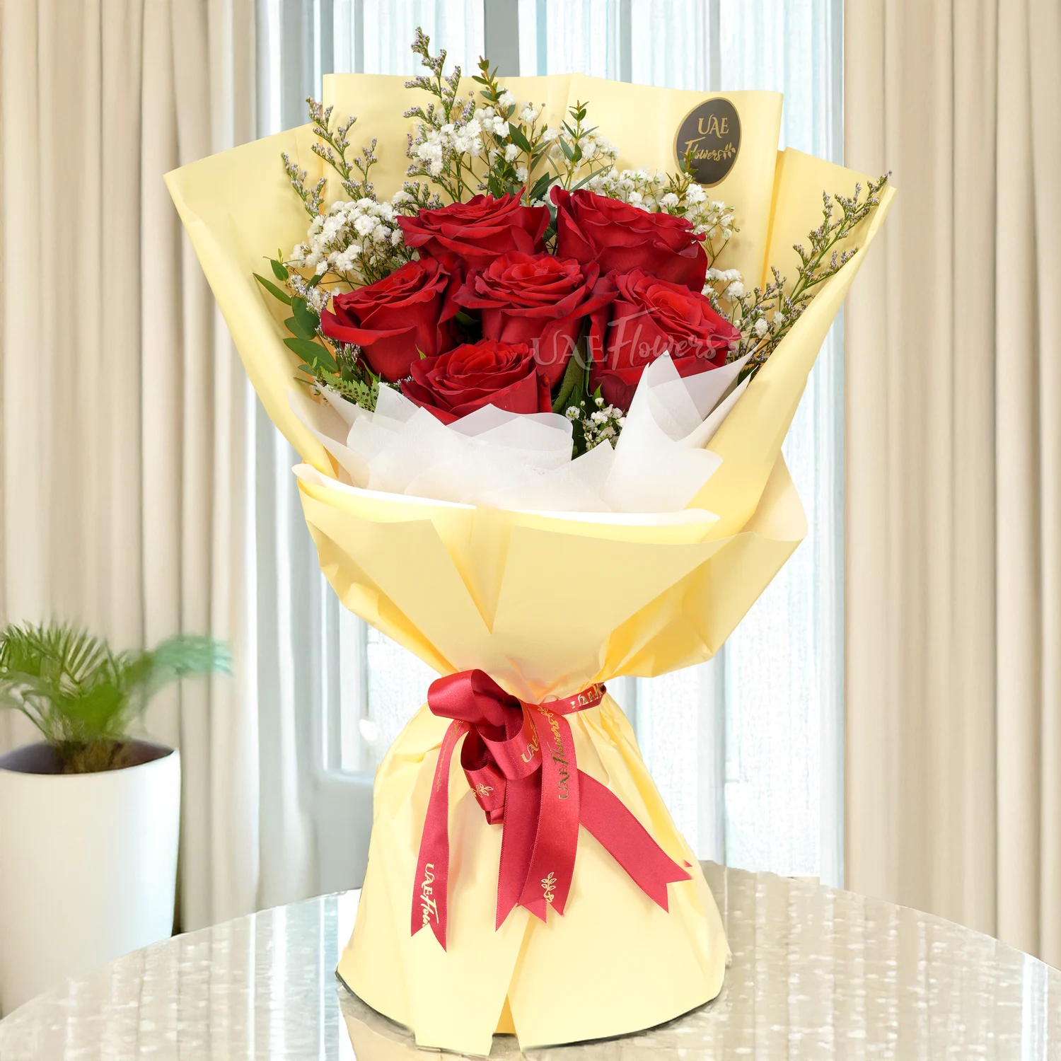 Bouquet of 6 red roses with green fillers in nice paper packing with ribbons, 1 kg fruit cake and a small brown teddy bear.