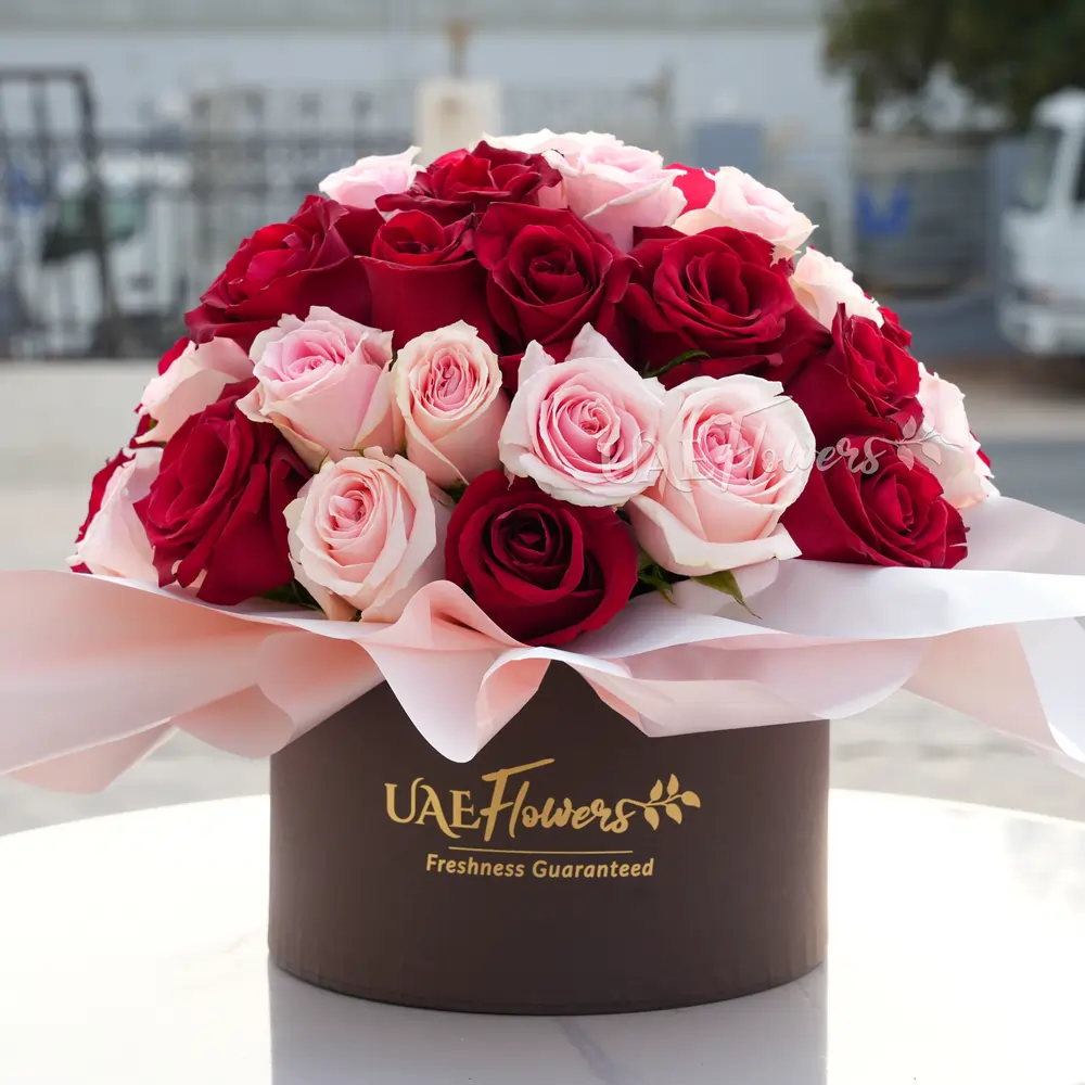 20 red and 20 pink roses neatly wrapped in a round box.