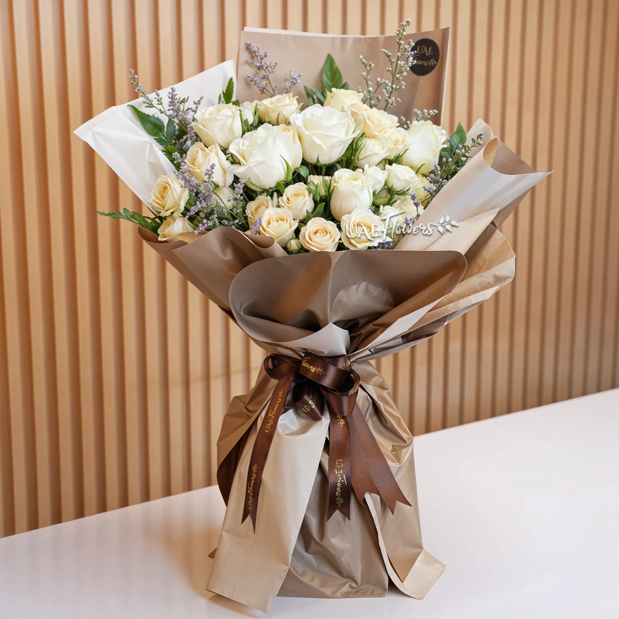 Bouquet of 8 white and peach roses and 2 peach spray roses with green fillers in nice wrapping, 1 kg chocolate cake and a small pink teddy bear.