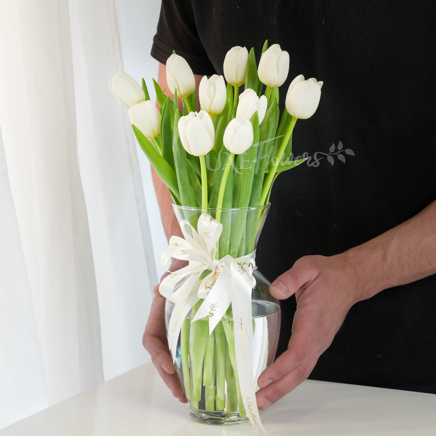 10 white tulips in a glass vase, 1 kg chocolate cake and a small white teddy bear.