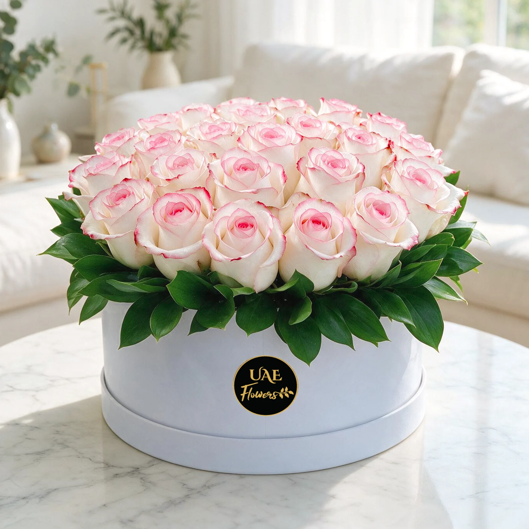 60 pink roses with green fillers arranged in a white round box